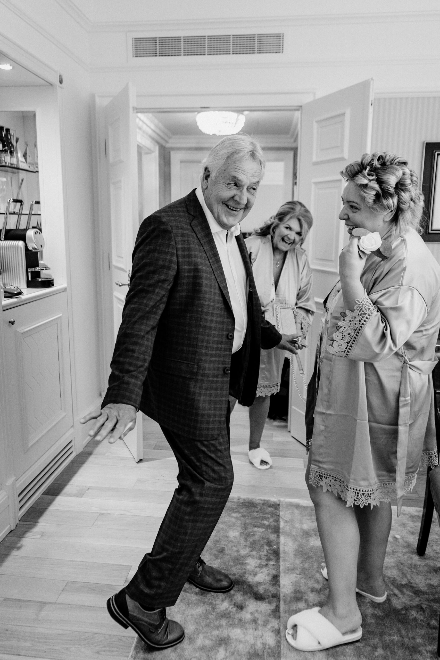 Bride getting ready at Powerscourt House, Wicklow, with her bridesmaids assisting in a luxurious suite.