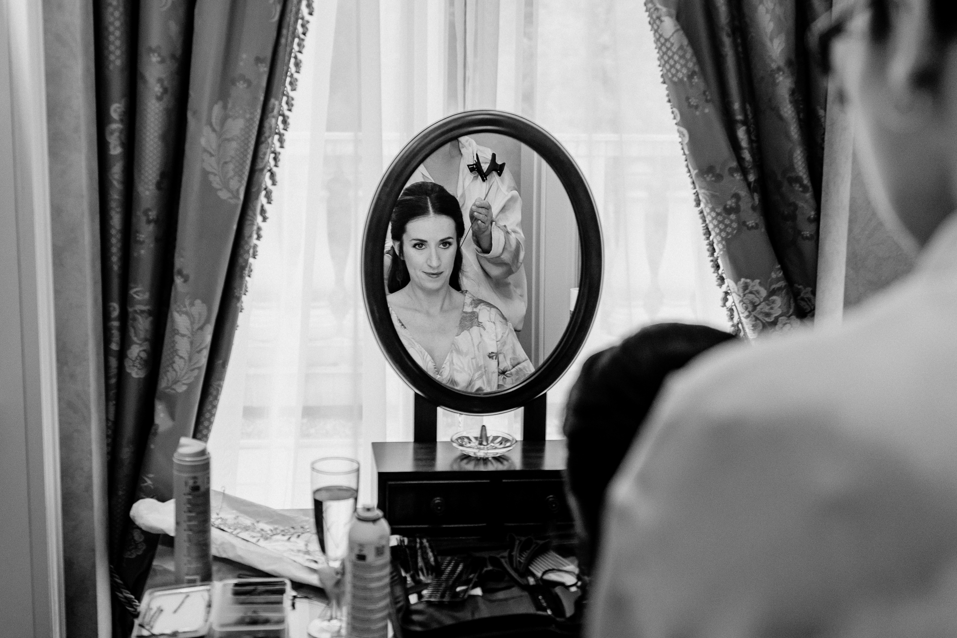 Bride getting ready at Powerscourt House, Wicklow, with her bridesmaids assisting in a luxurious suite.