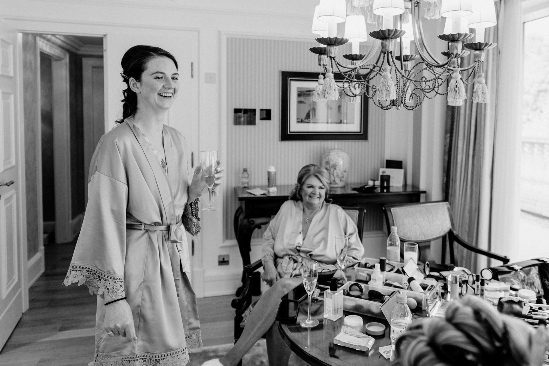 Bride getting ready at Powerscourt House, Wicklow, with her bridesmaids assisting in a luxurious suite.