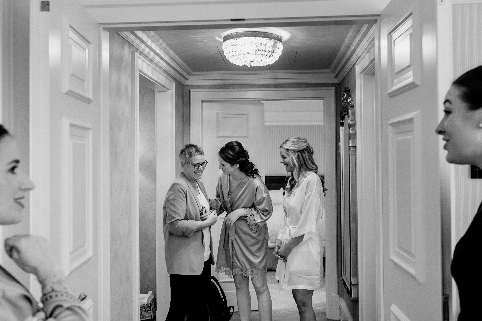 Bride getting ready at Powerscourt House, Wicklow, with her bridesmaids assisting in a luxurious suite.