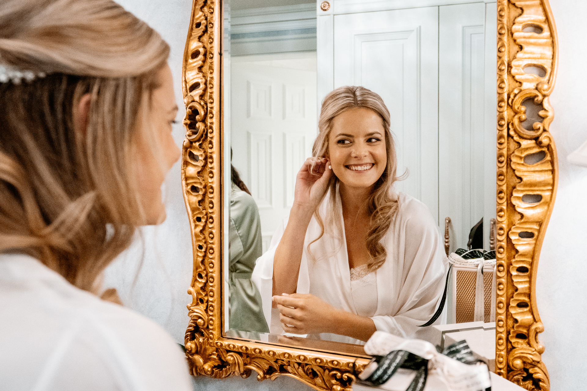 Bride getting ready at Powerscourt House, Wicklow, with her bridesmaids assisting in a luxurious suite.