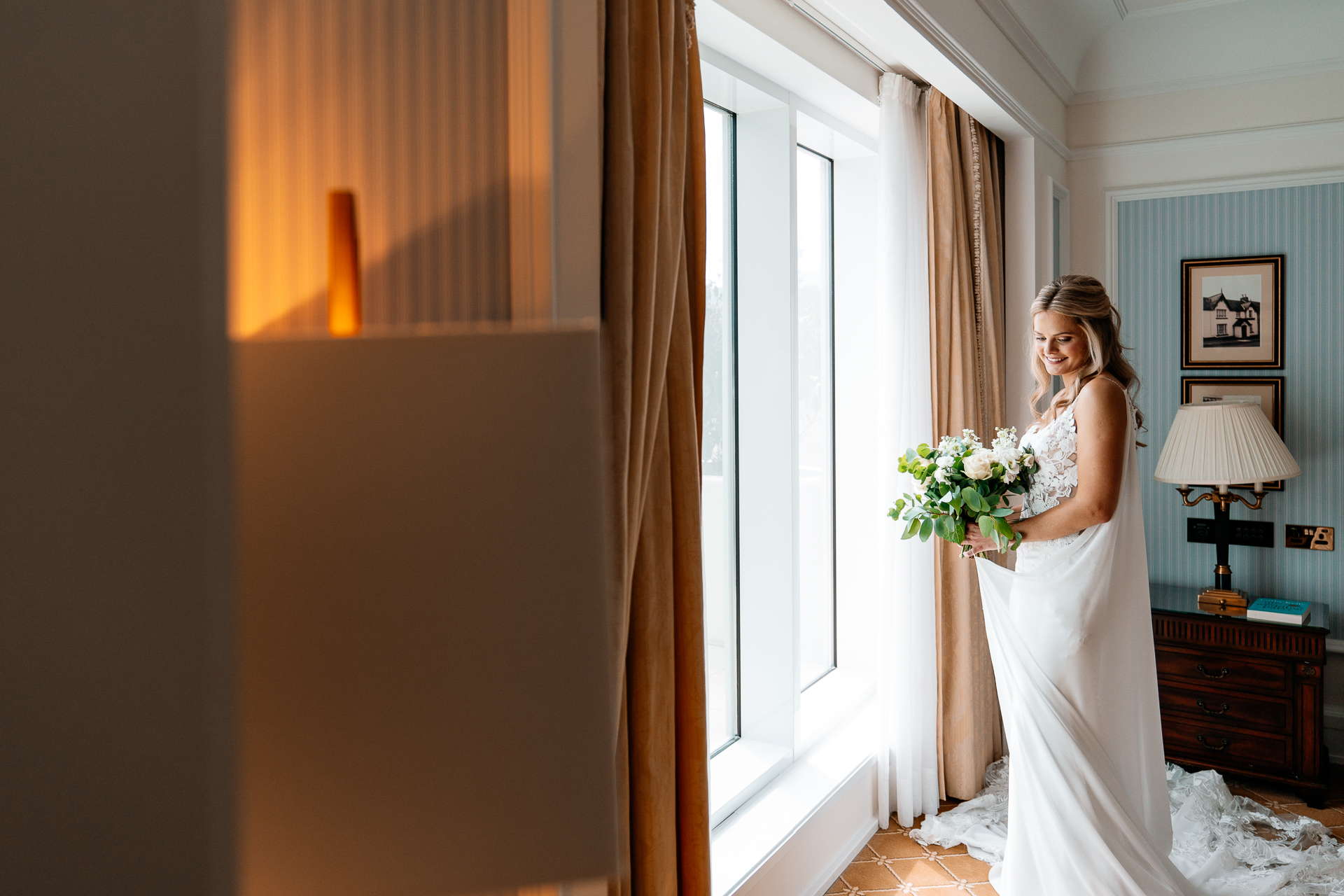 Bride getting ready at Powerscourt House, Wicklow, with her bridesmaids assisting in a luxurious suite.