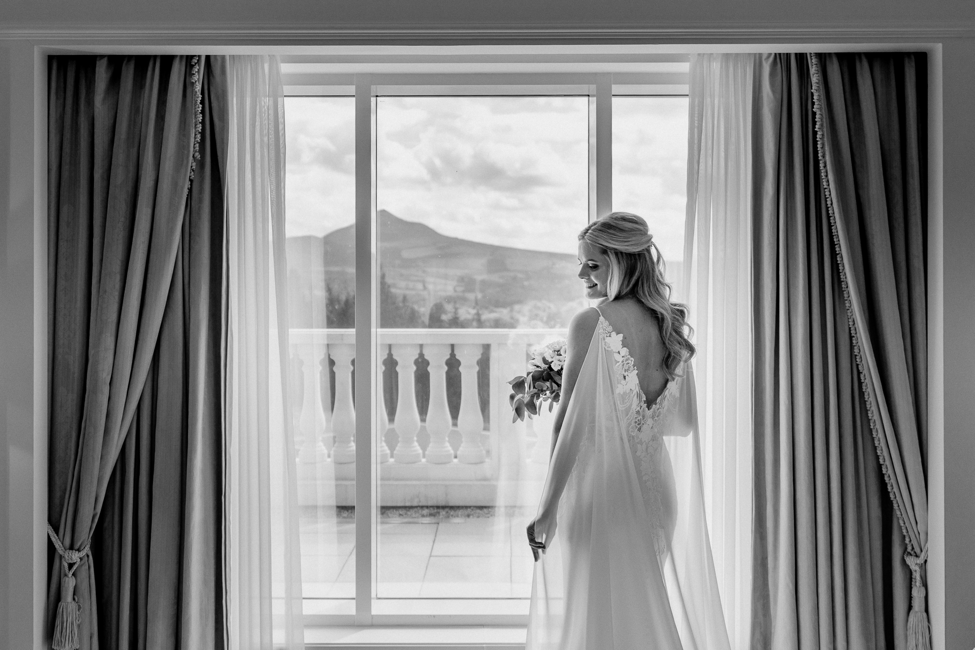 Bride getting ready at Powerscourt House, Wicklow, with her bridesmaids assisting in a luxurious suite.