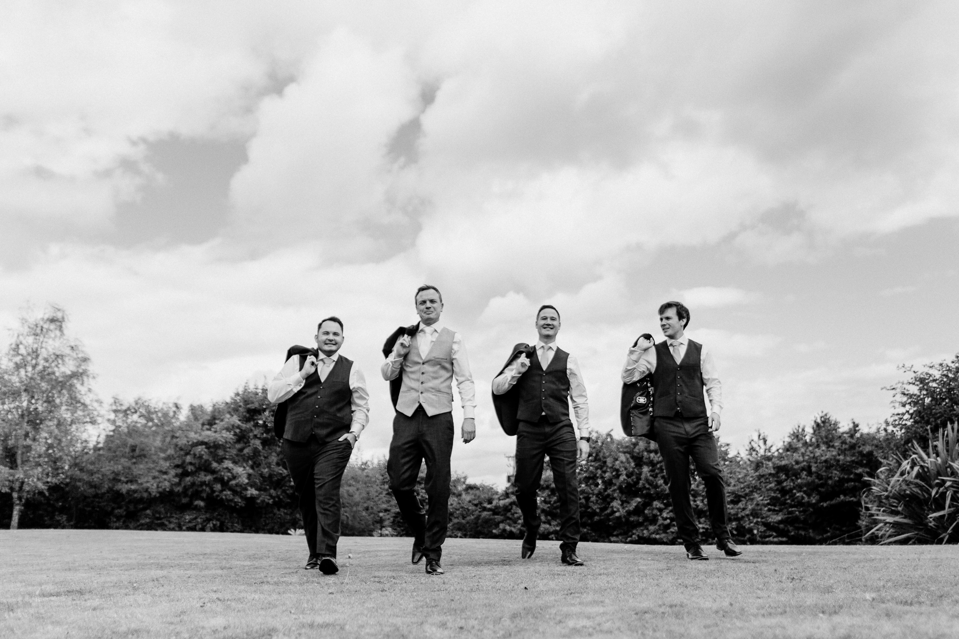 Groom adjusting his tie in the grand interiors of Powerscourt House in Wicklow.