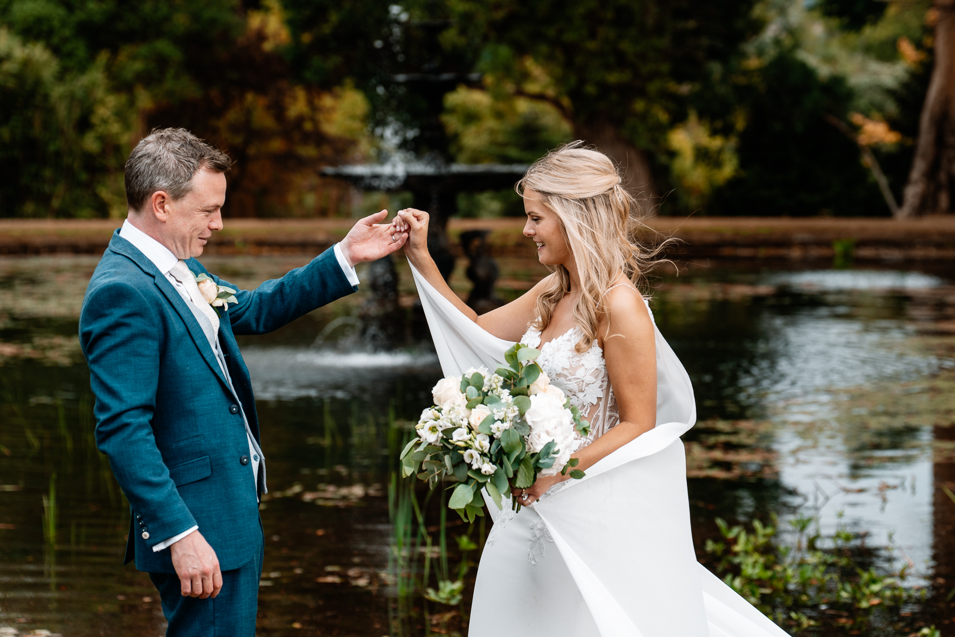 Bride and groom sharing a romantic moment at the gardens of Powerscourt House in Wicklow.