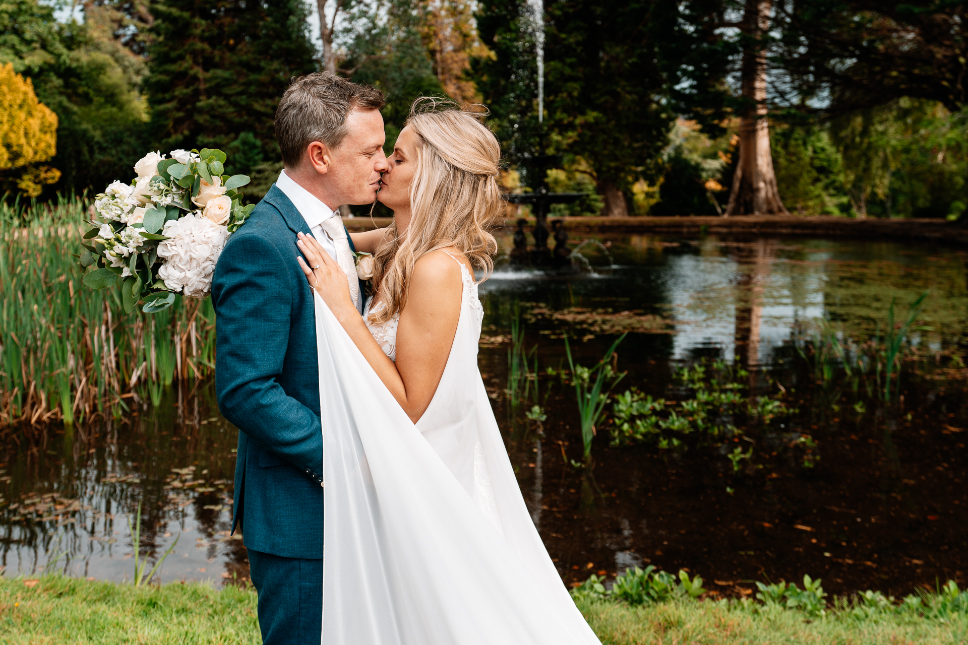 Bride and groom sharing a romantic moment at the gardens of Powerscourt House in Wicklow.