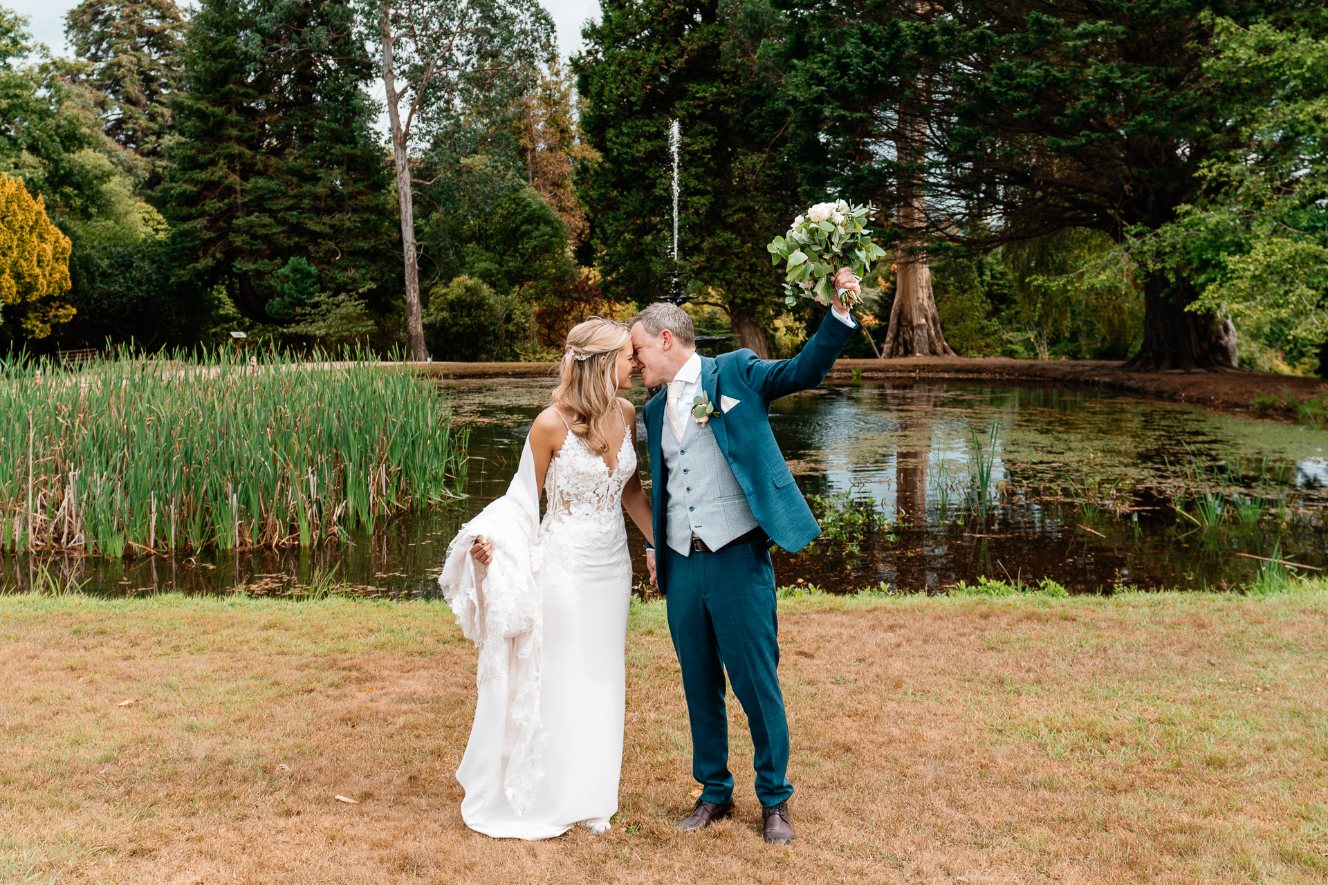 Bride and groom sharing a romantic moment at the gardens of Powerscourt House in Wicklow.