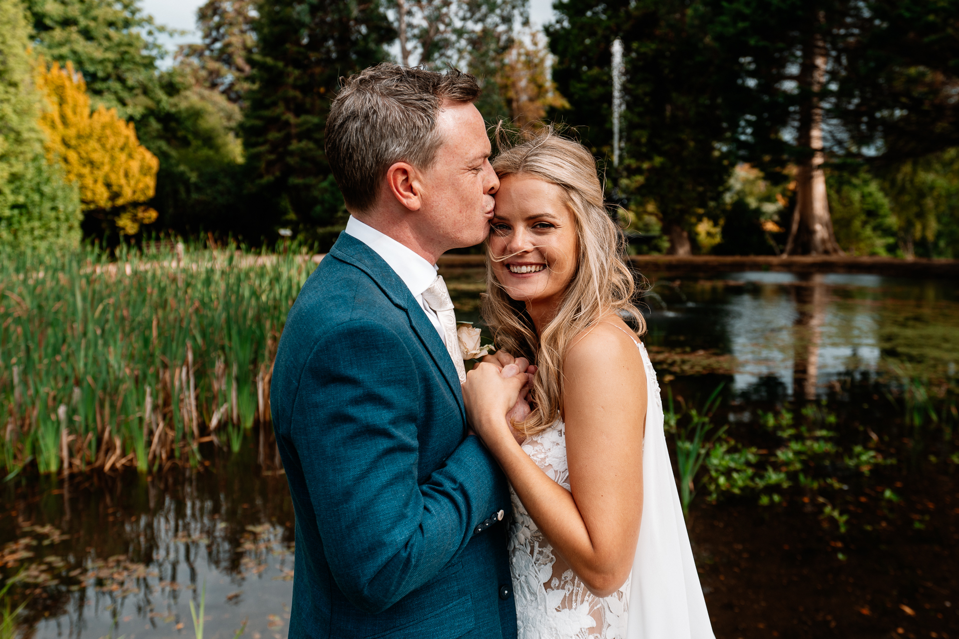 Bride and groom sharing a romantic moment at the gardens of Powerscourt House in Wicklow.