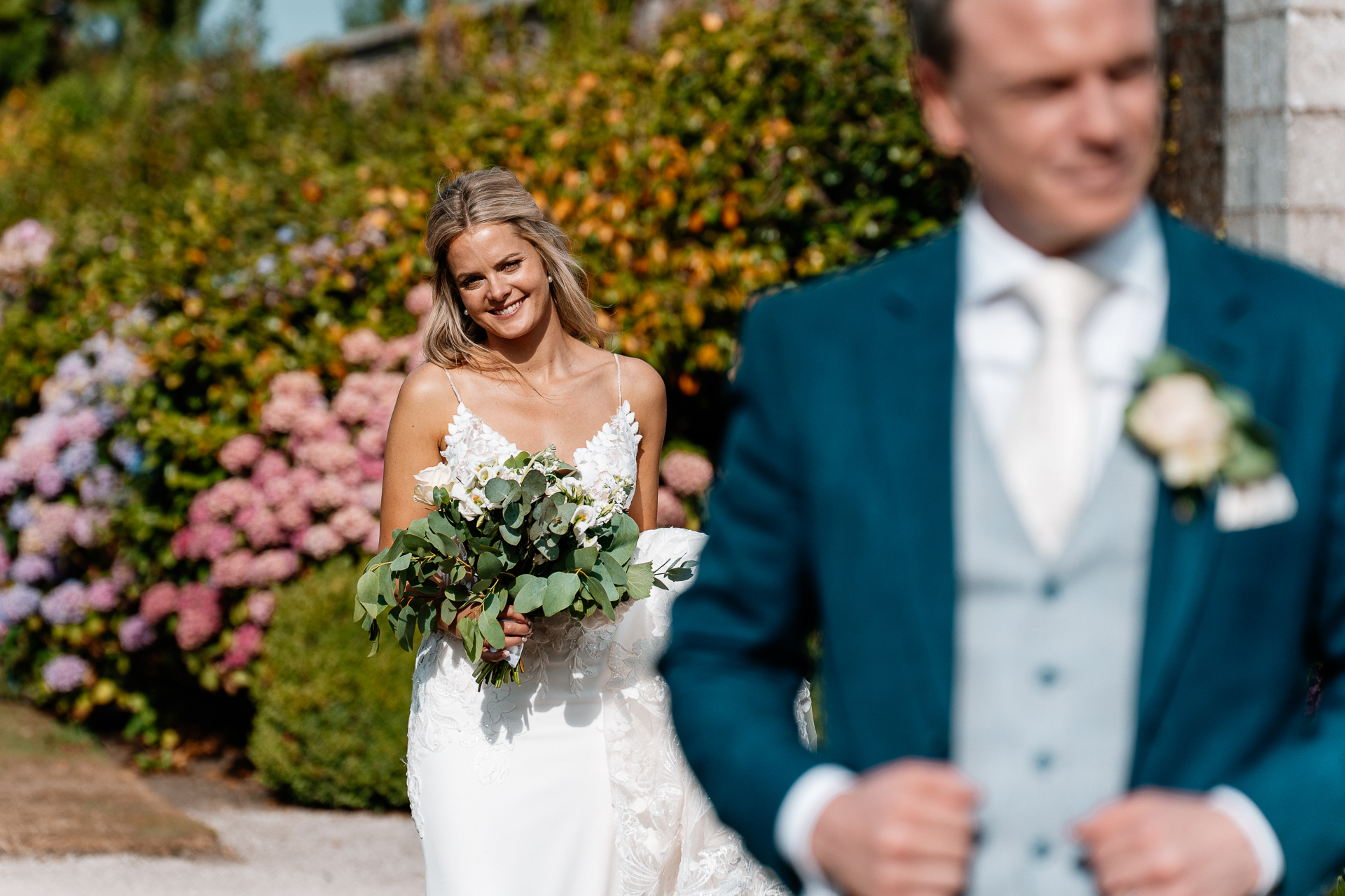 Bride and groom sharing a romantic moment at the gardens of Powerscourt House in Wicklow.