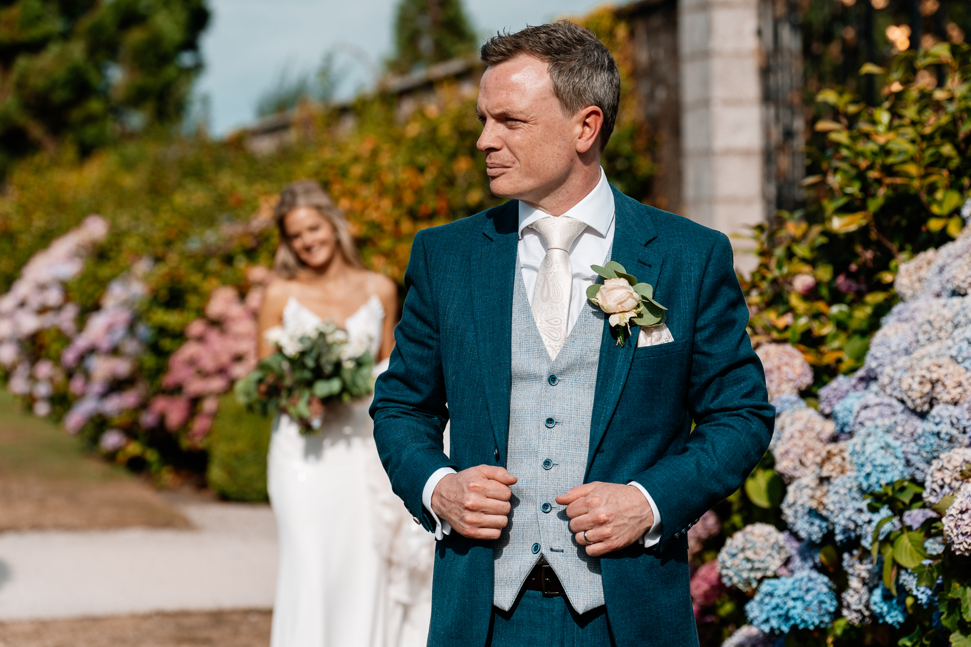 Bride and groom sharing a romantic moment at the gardens of Powerscourt House in Wicklow.