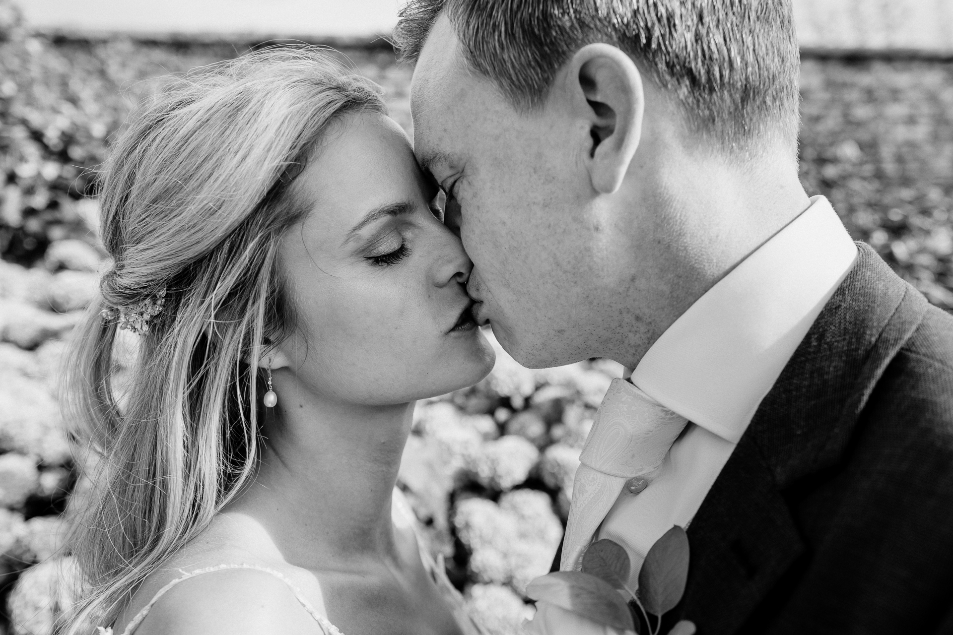 Bride and groom sharing a romantic moment at the gardens of Powerscourt House in Wicklow.