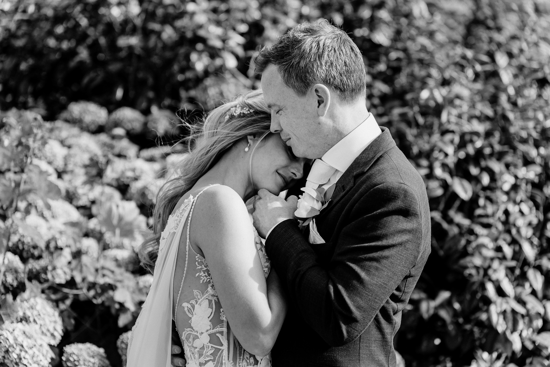 Bride and groom sharing a romantic moment at the gardens of Powerscourt House in Wicklow.