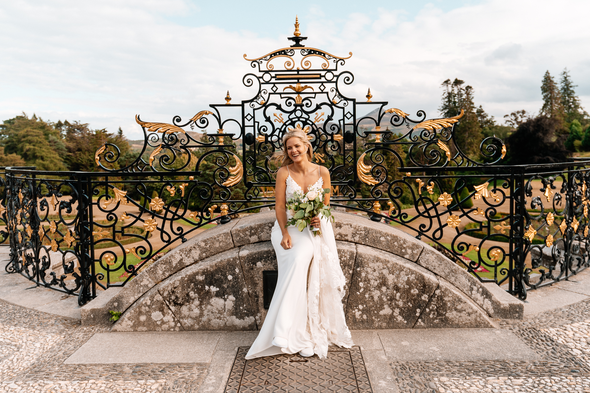 Bride and groom sharing a romantic moment at the gardens of Powerscourt House in Wicklow.