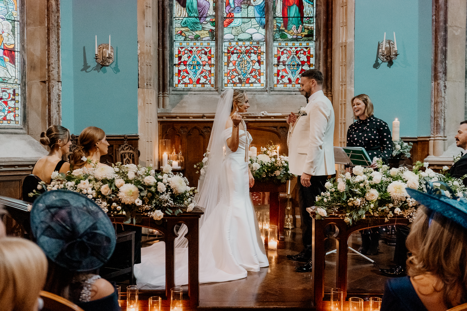 A couple exchanging vows inside the chapel at Markree Castle during their wedding ceremony in Sligo, Ireland.