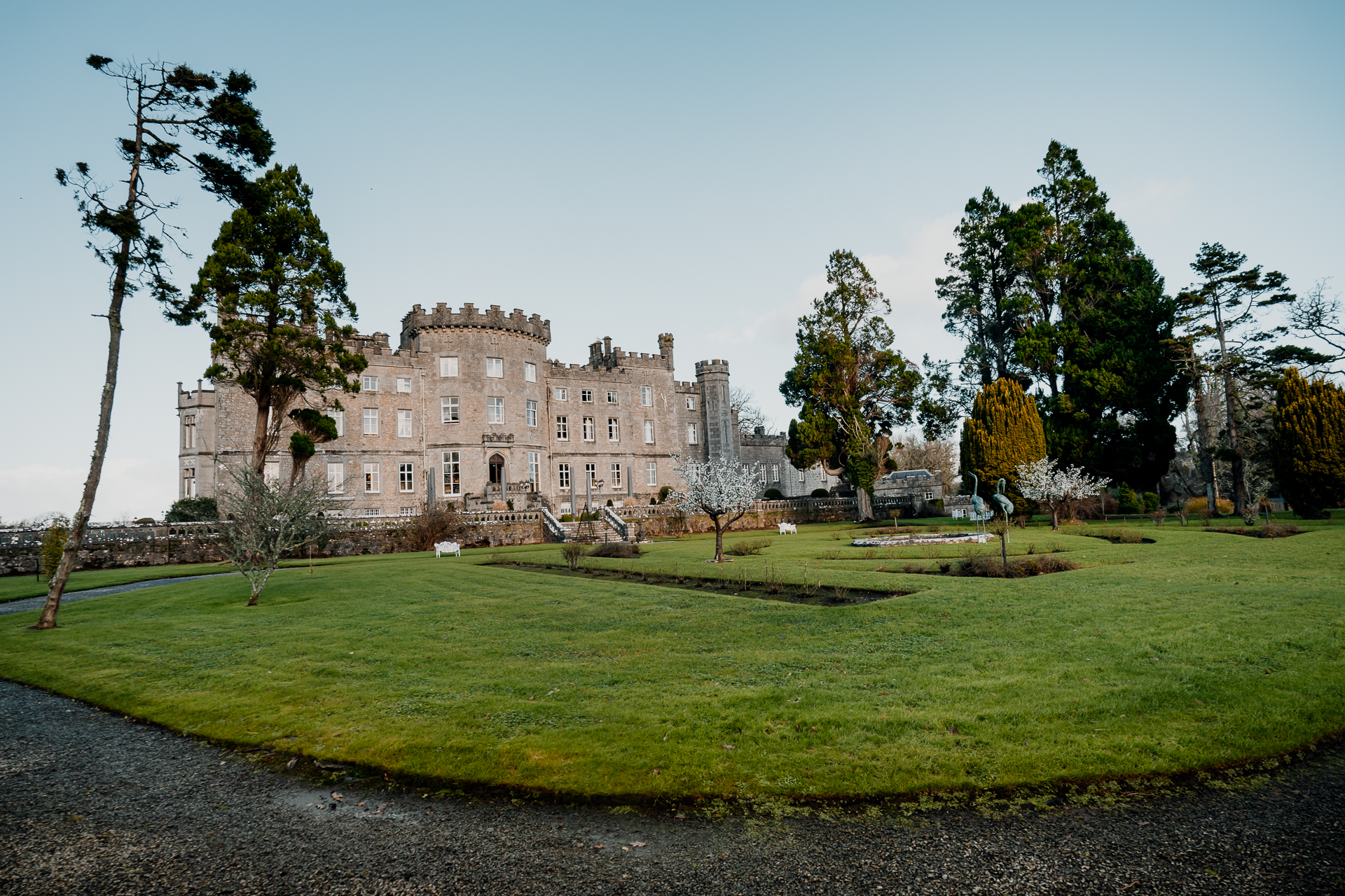 A large building with trees and grass