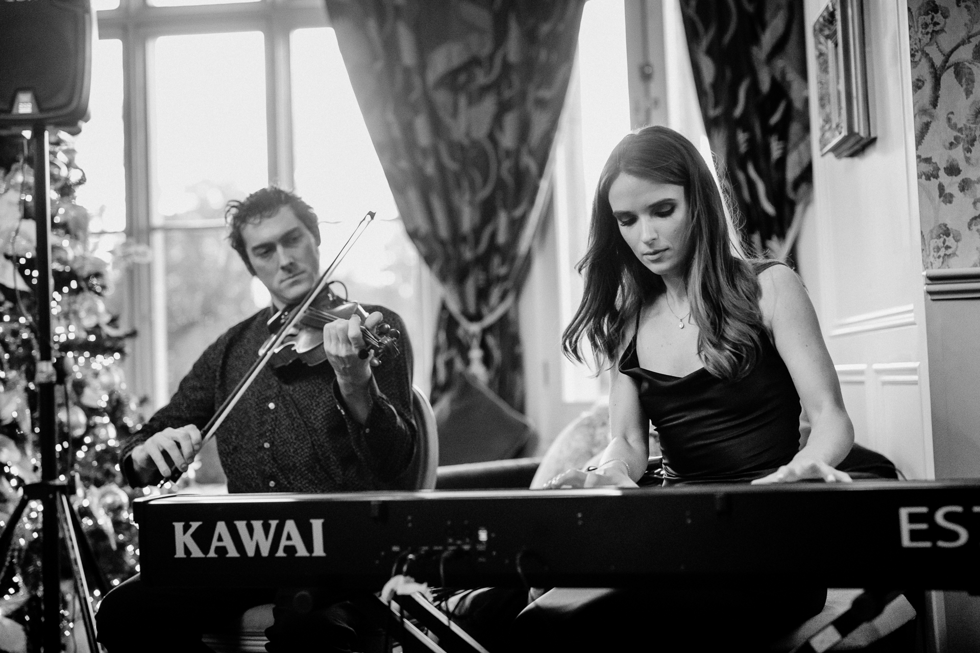 A man and woman playing the piano