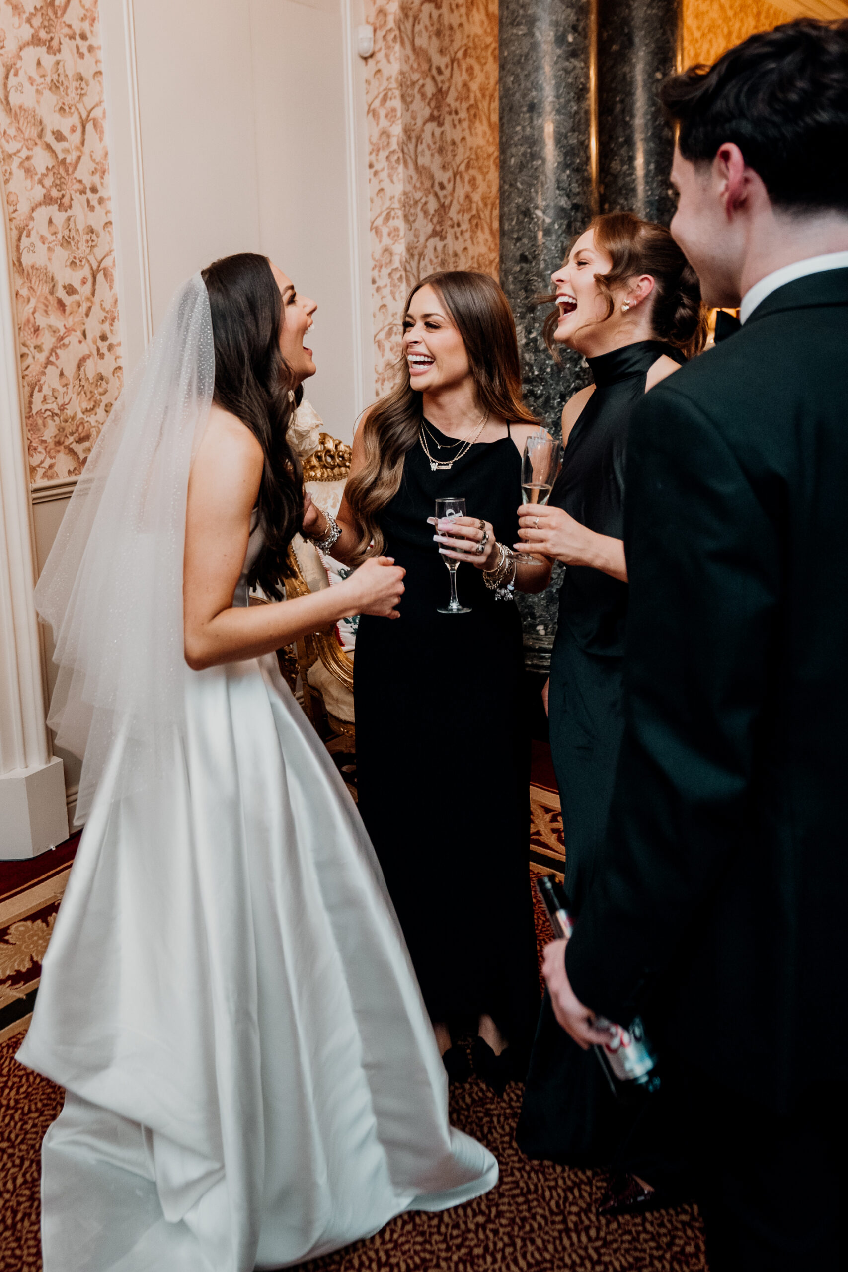 A person in a wedding dress holding a glass of wine