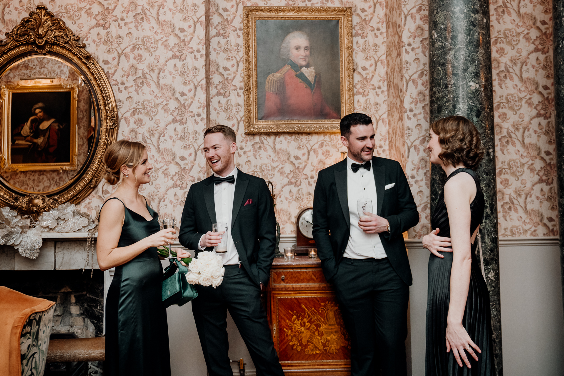 A group of people standing in a room with a person holding flowers