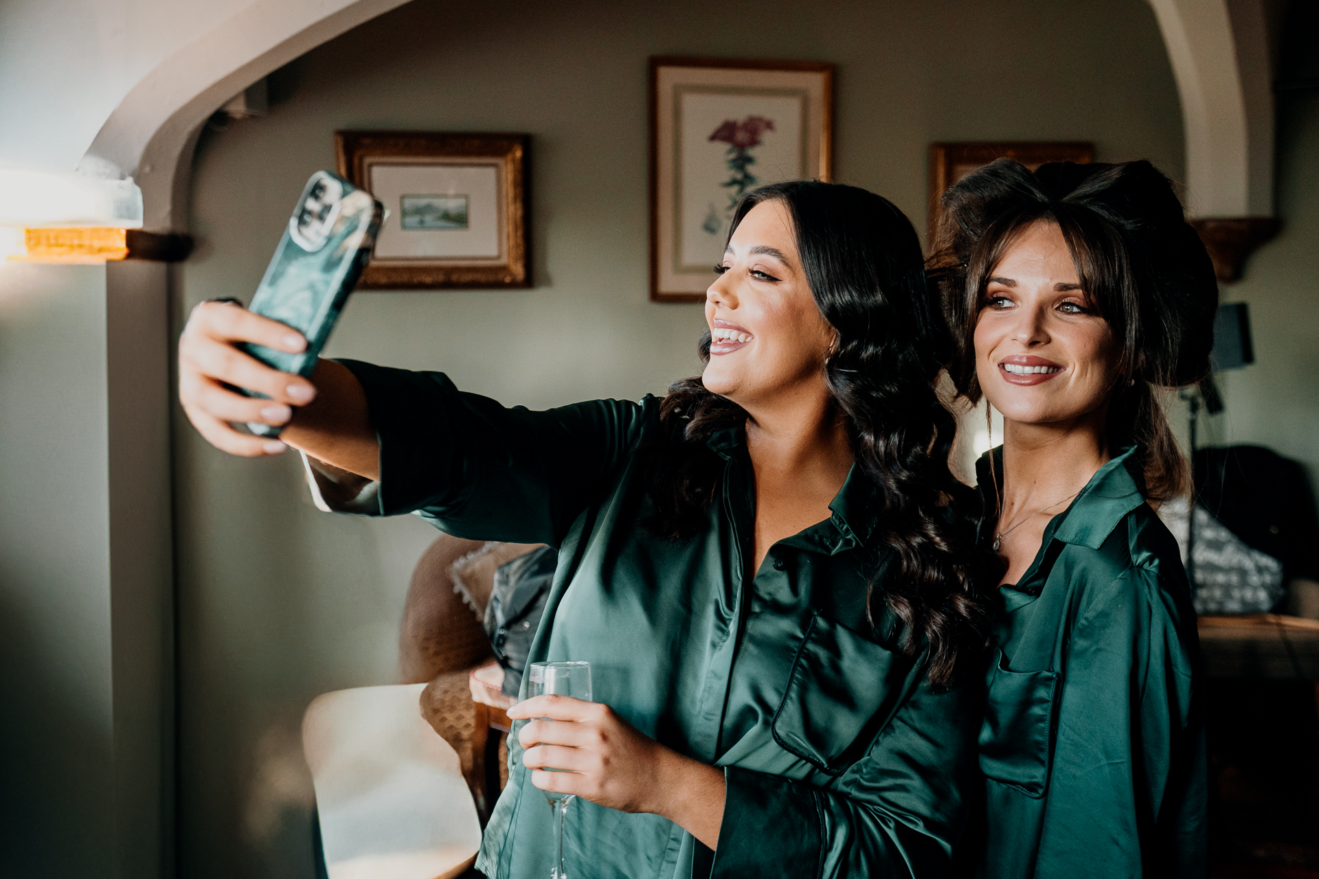 A couple of women holding a bottle