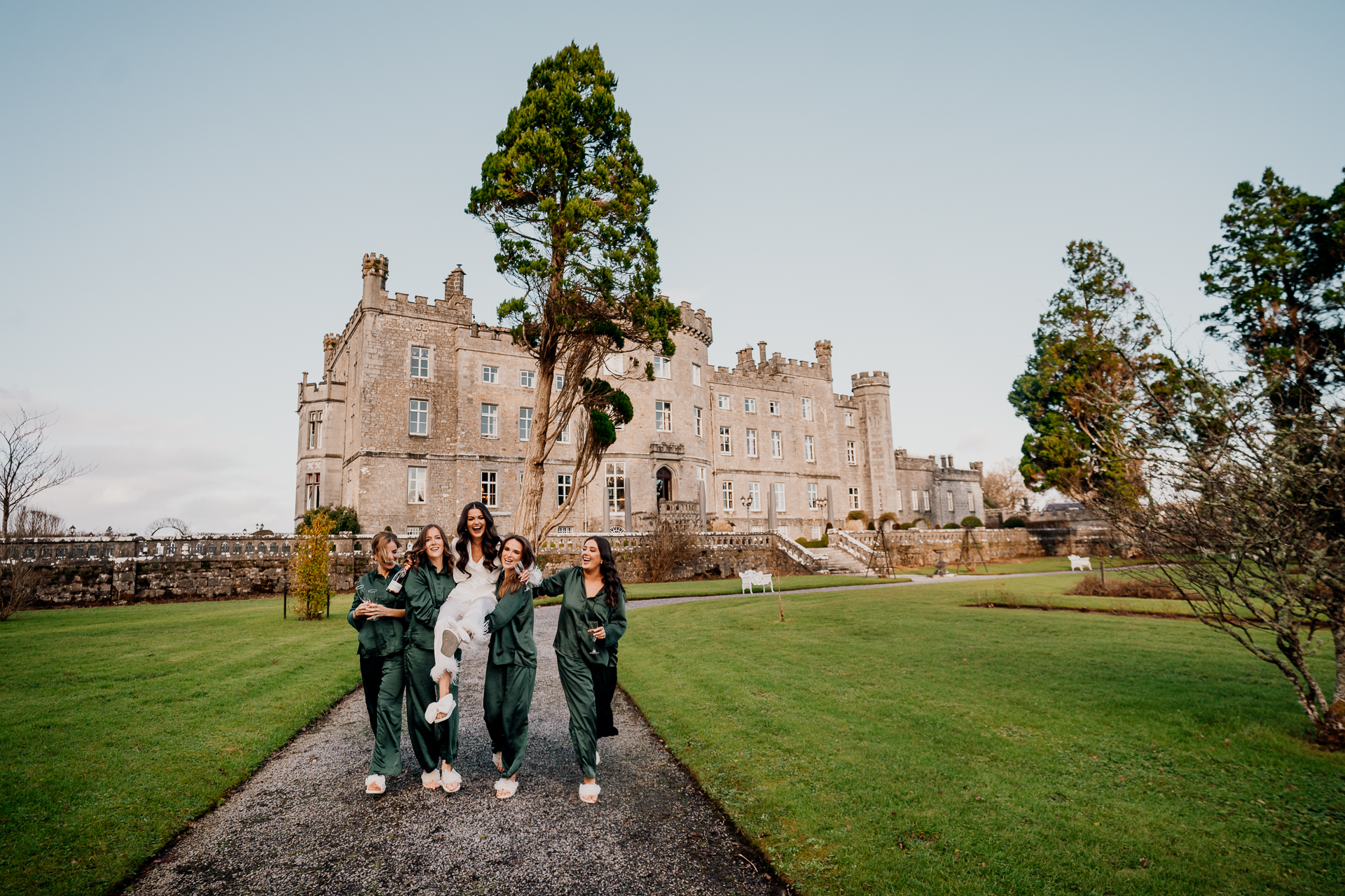A group of women posing for a photo in front of a large building