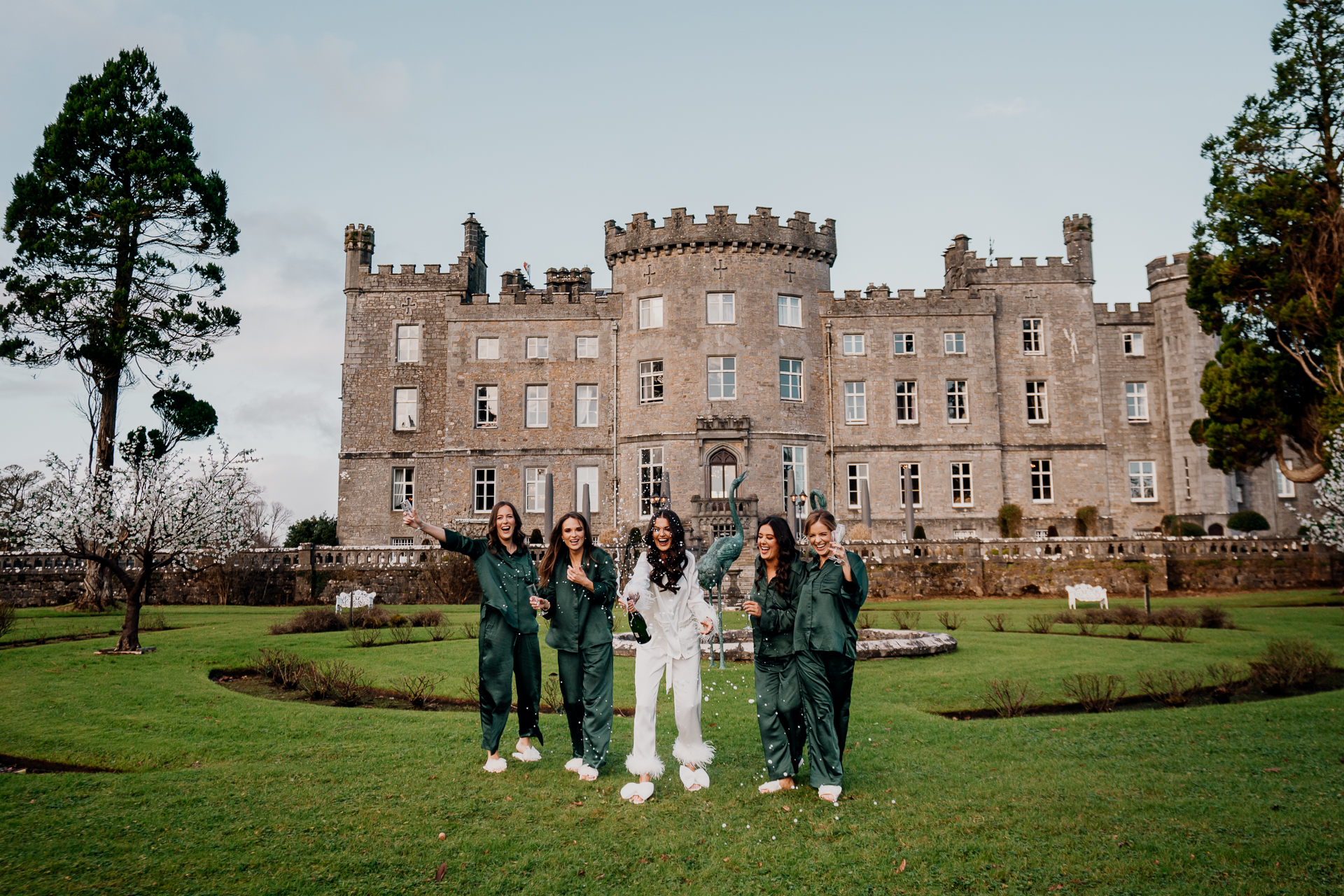 A group of people posing for a photo in front of a large building