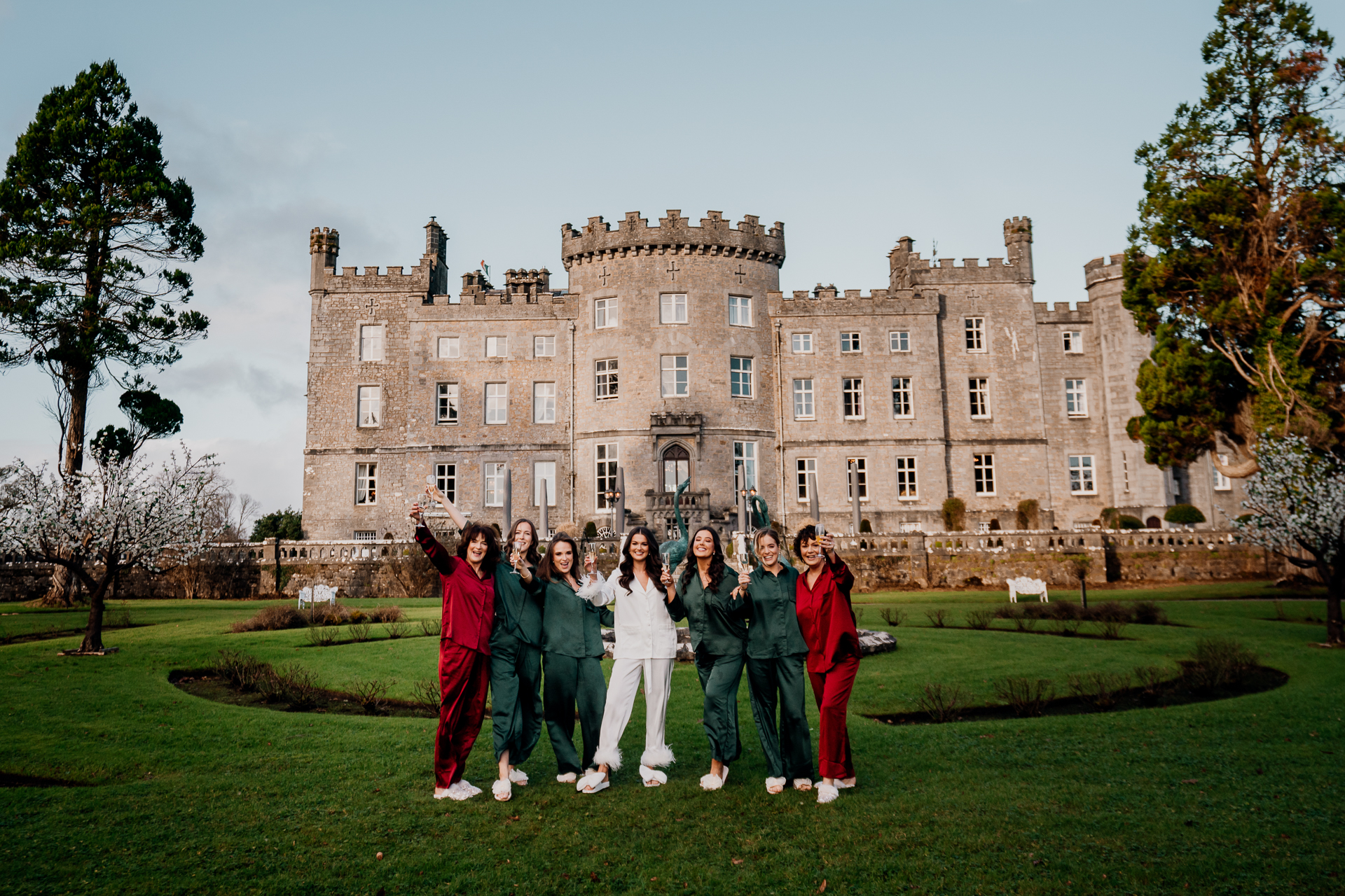 A group of people posing for a photo in front of a large building