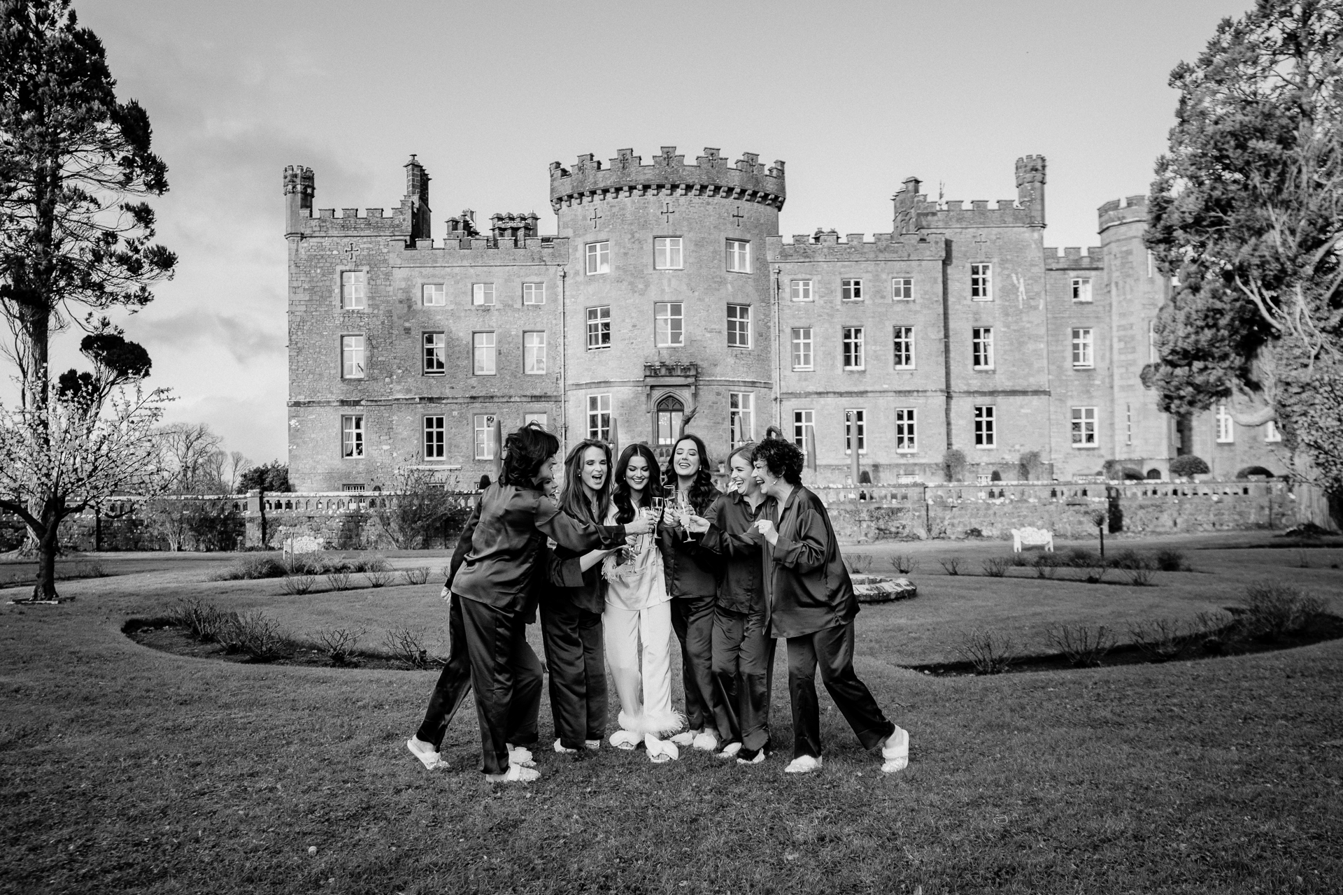 A group of people posing for a photo in front of a large building