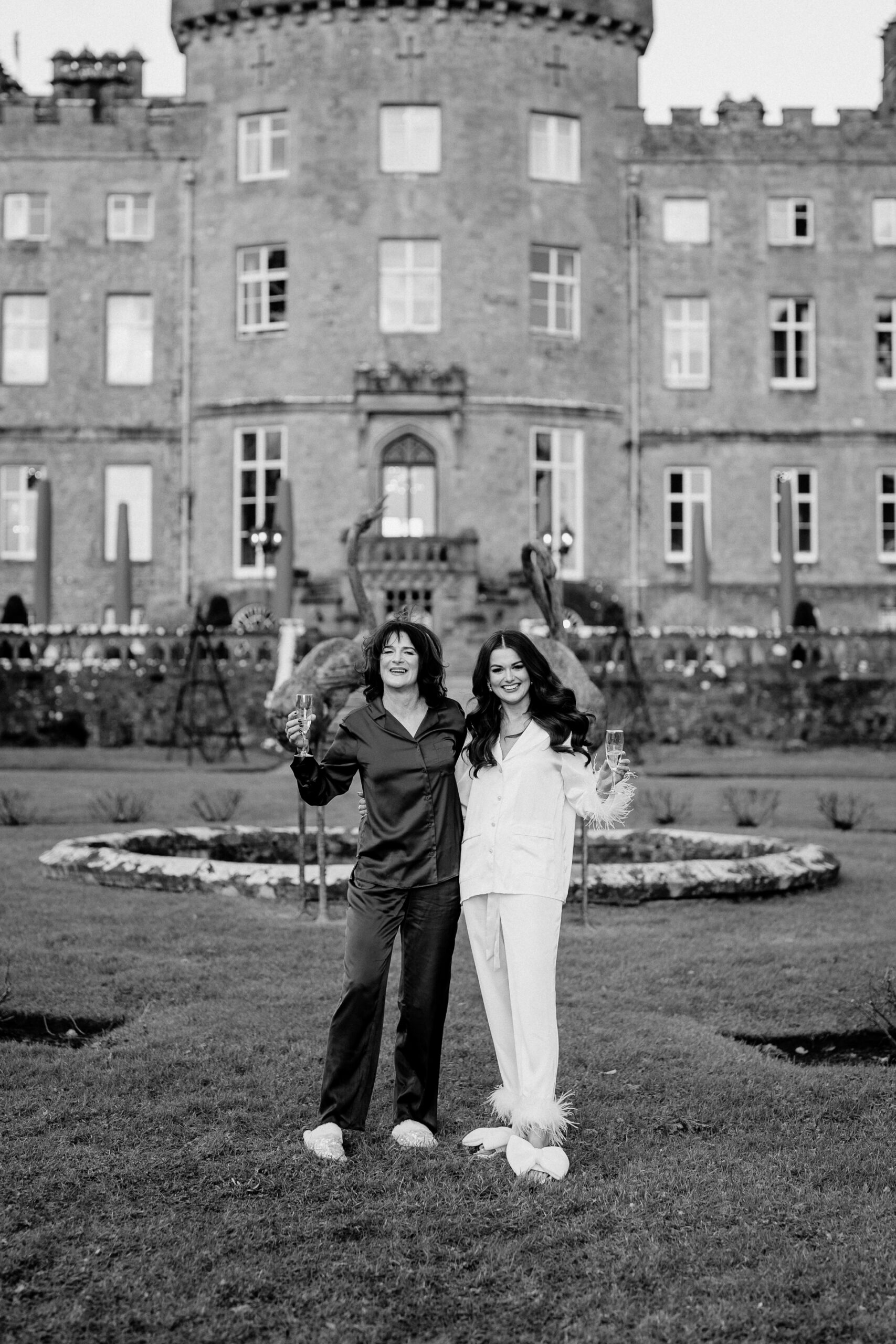 A man and woman posing in front of a building