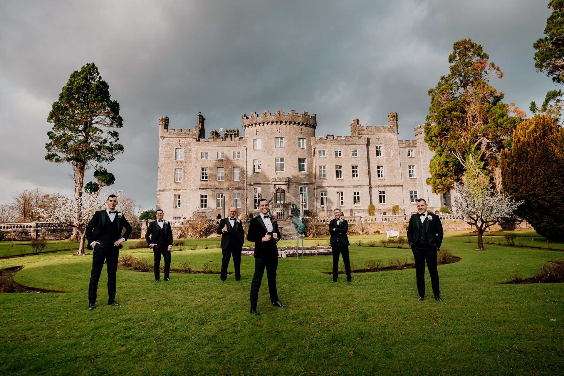 A group of men in suits standing in front of a large building
