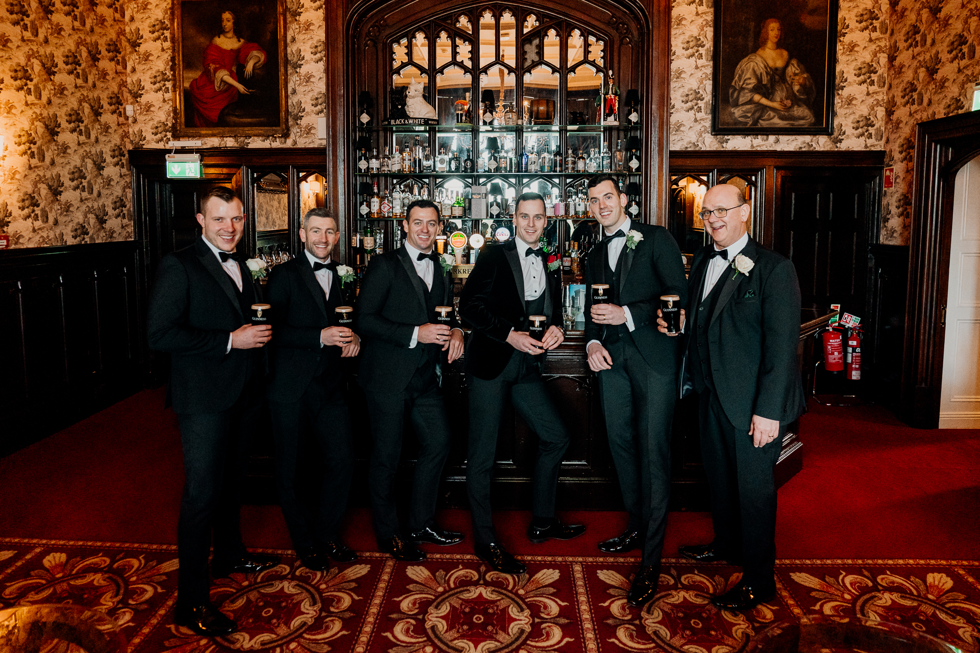A group of men holding wine glasses