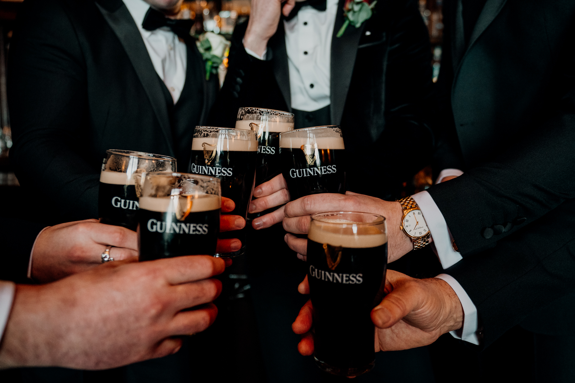 A group of people holding glasses of beer