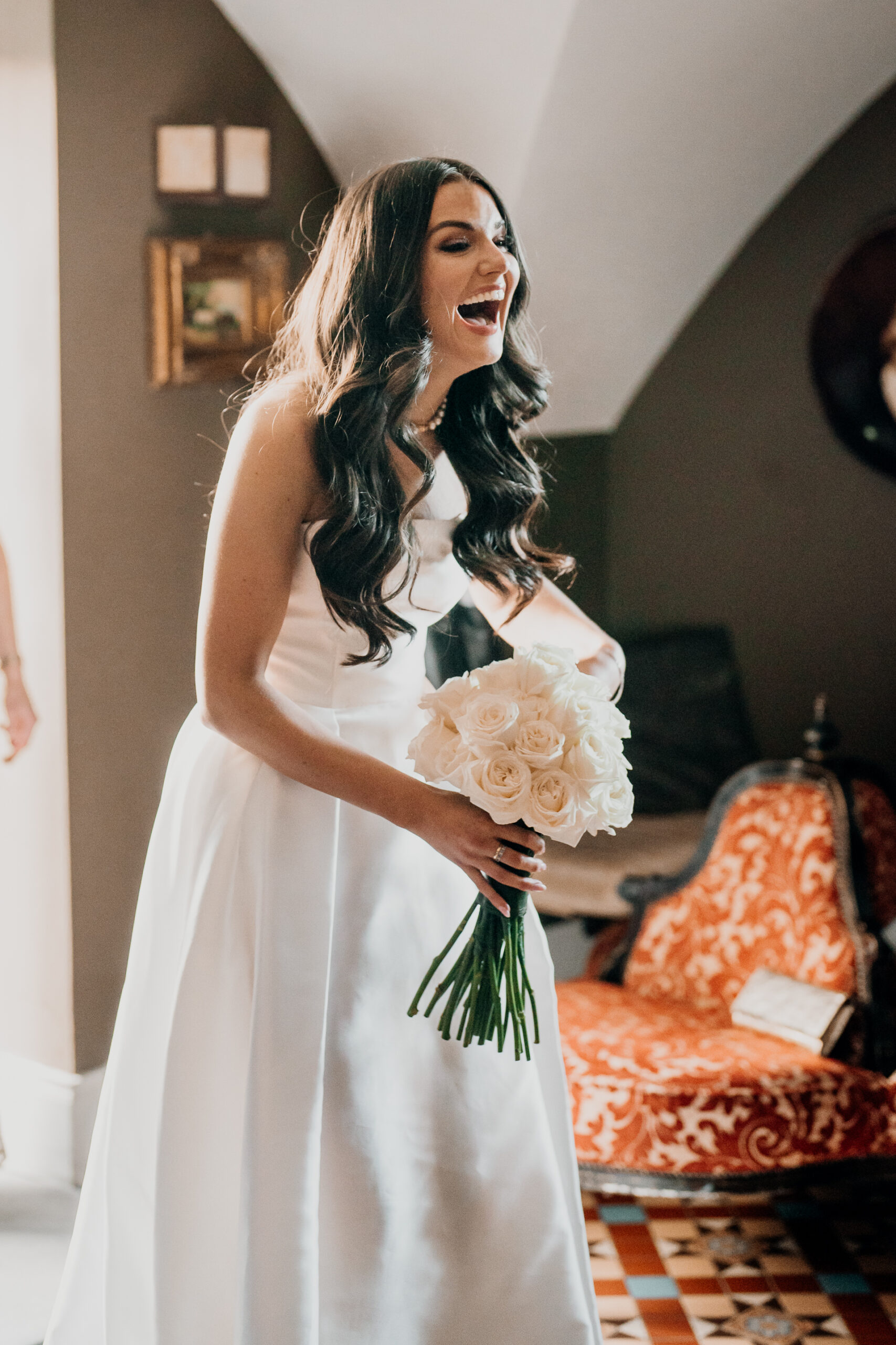 A woman in a wedding dress holding a bouquet of flowers