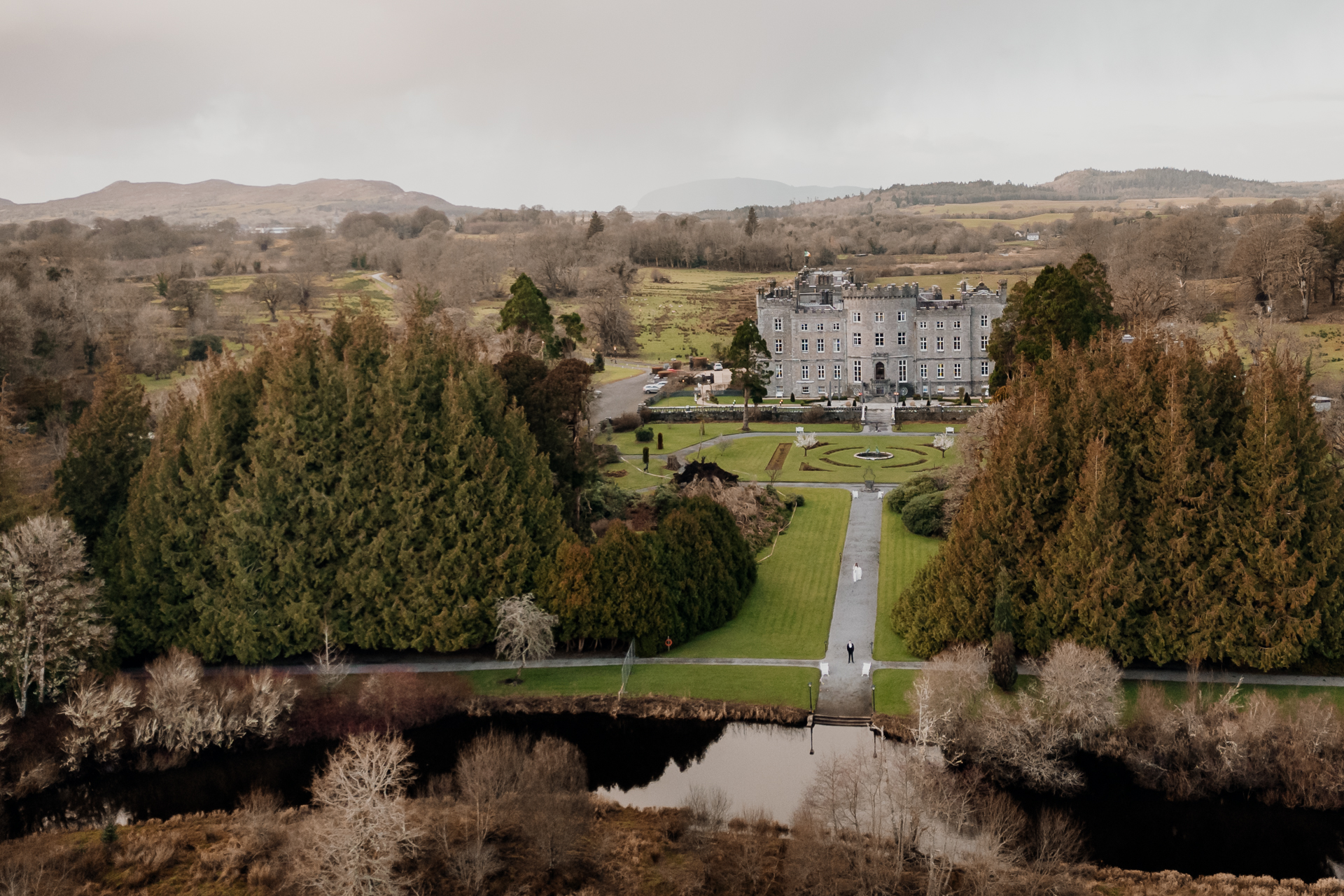 A large building with a pond in front of it