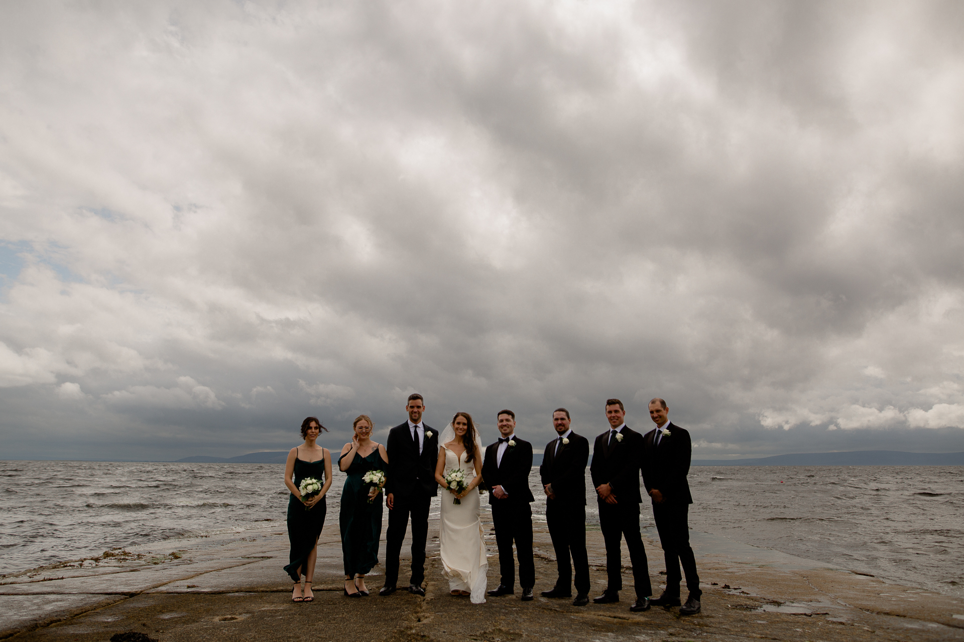 A group of people posing for a photo on a beach