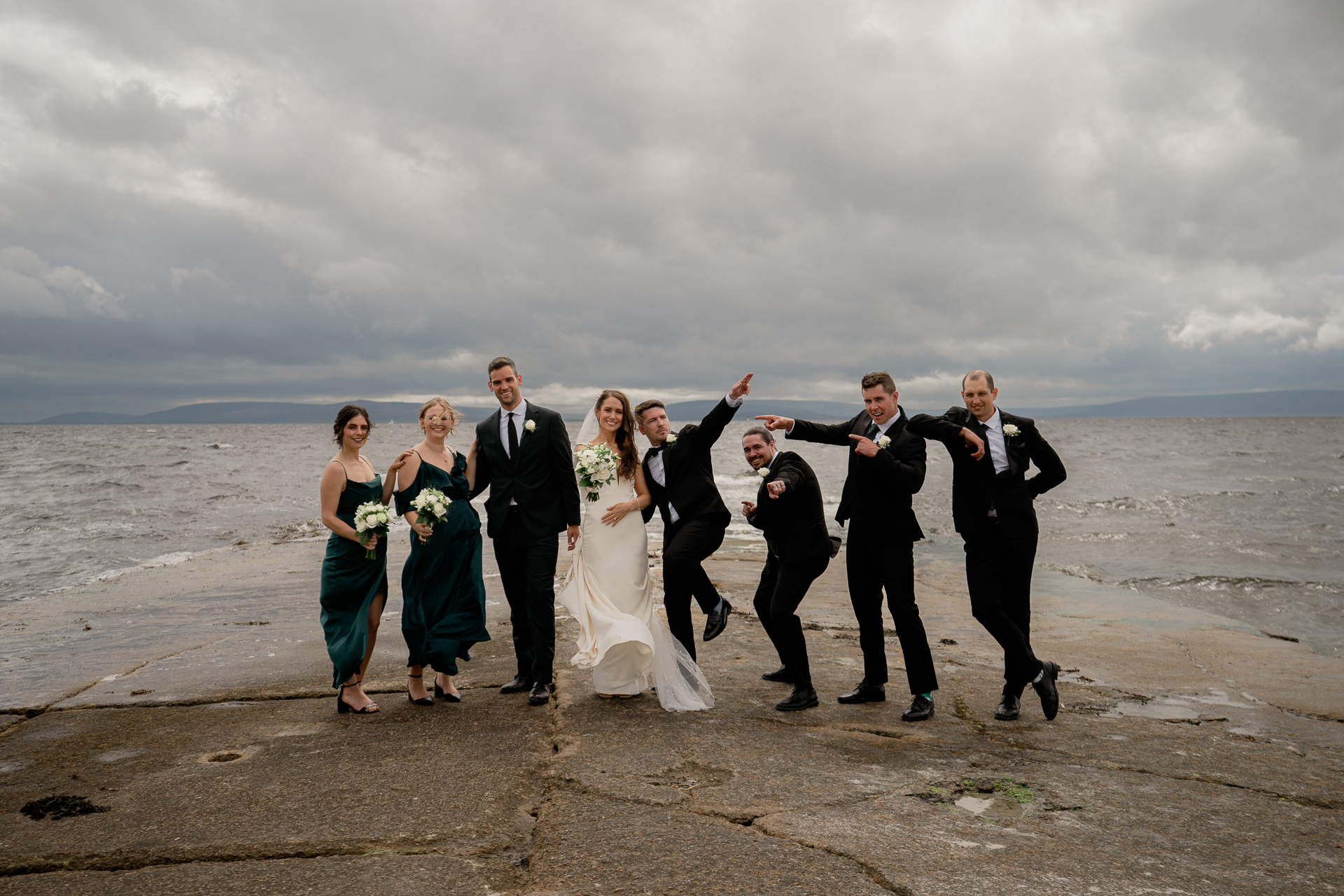 A group of people posing for a photo on a beach