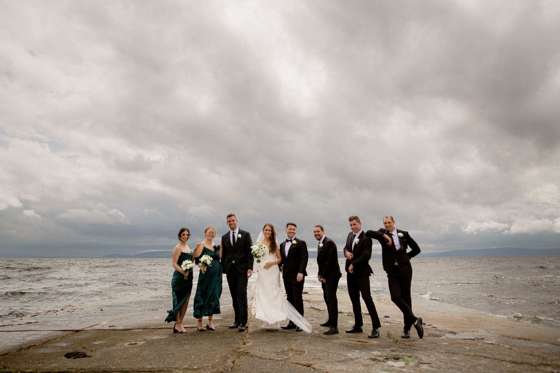 A group of people posing for a photo on a beach