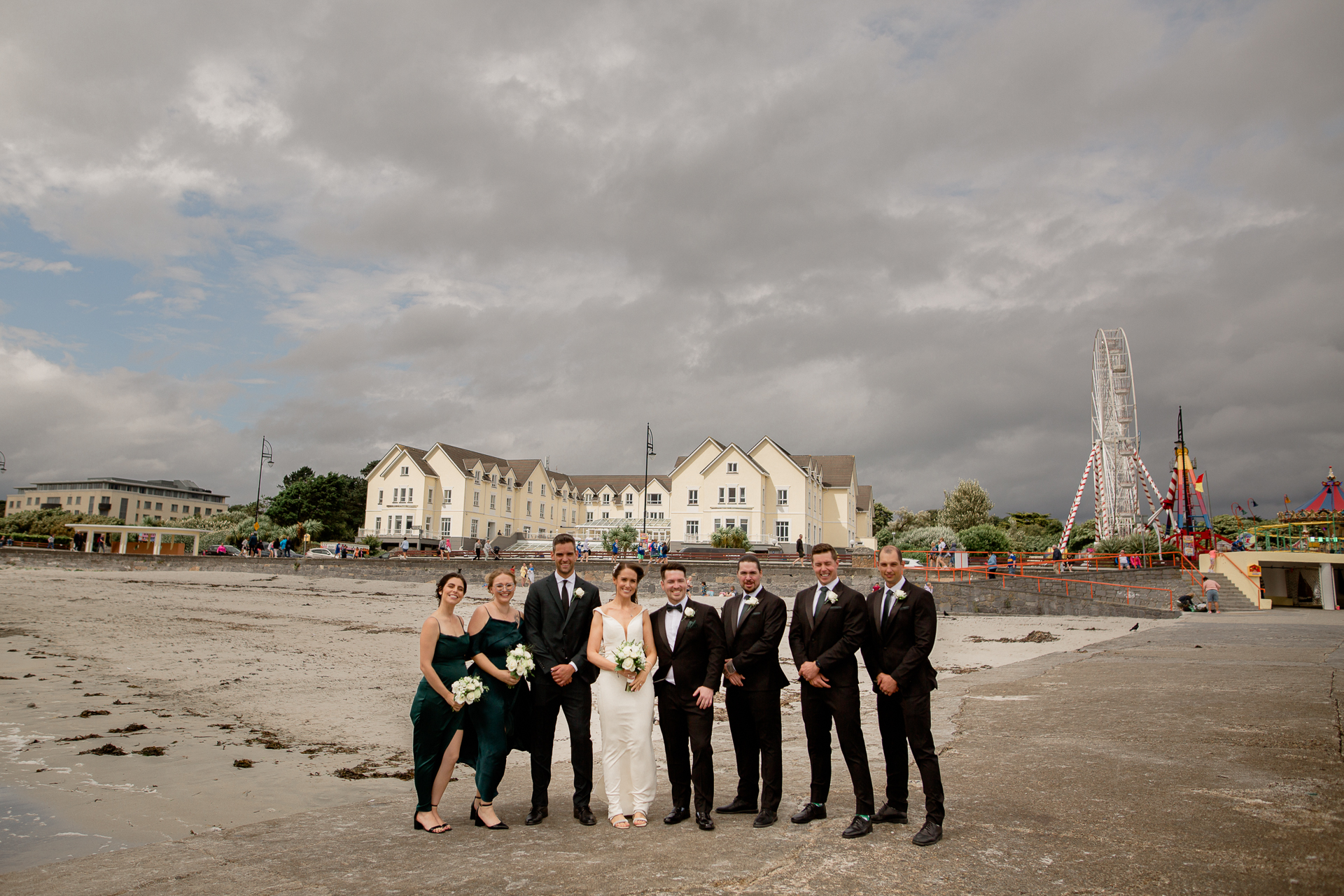 A group of people posing for a photo in front of a large tower