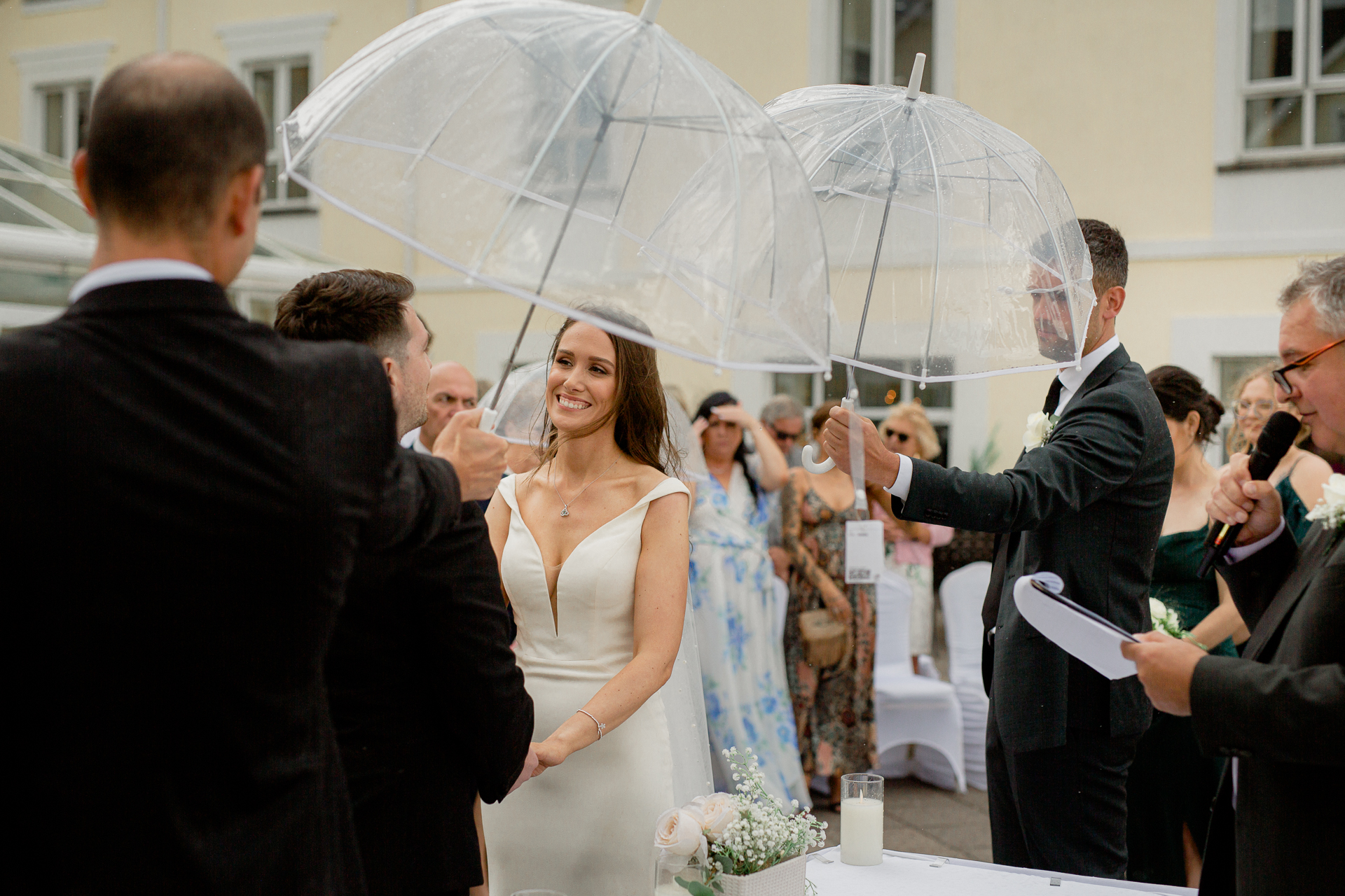 A person in a white dress holding an umbrella