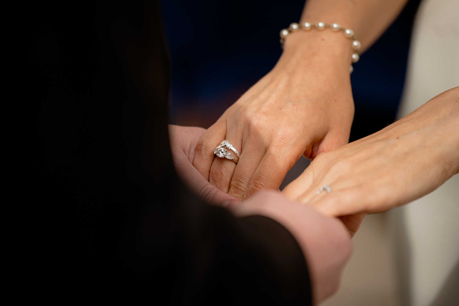 A woman's hand with a wedding ring on it