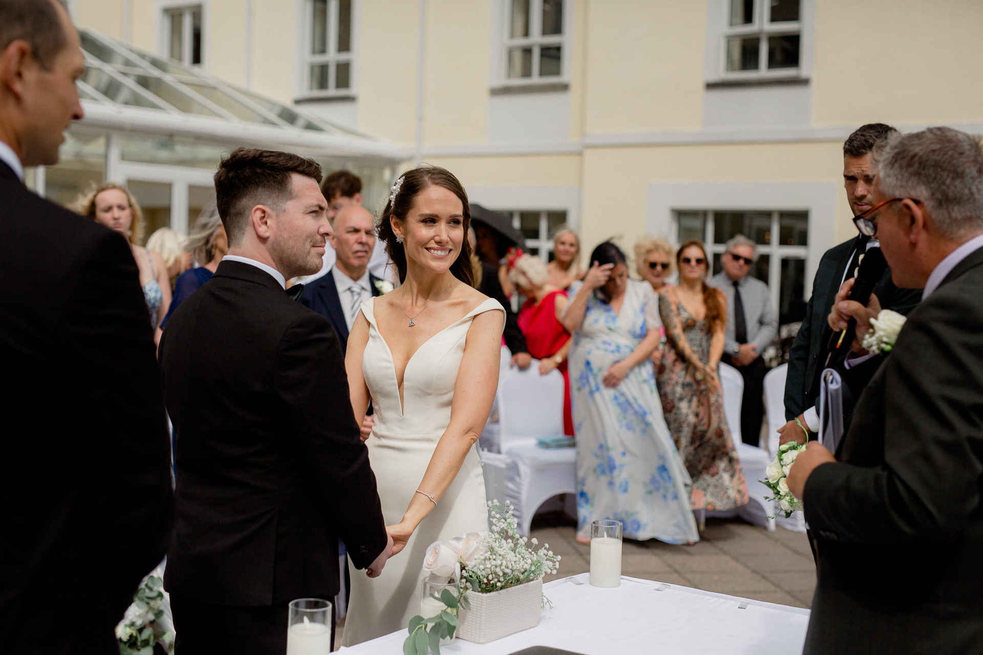 A woman in a white dress and a man in a suit and a woman in a white dress