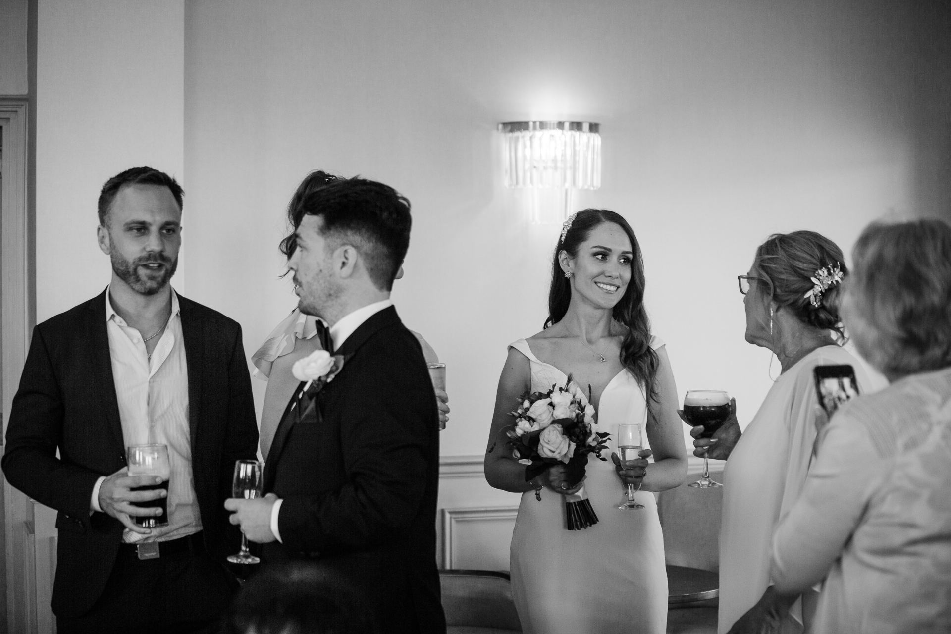 A bride and groom holding wine glasses