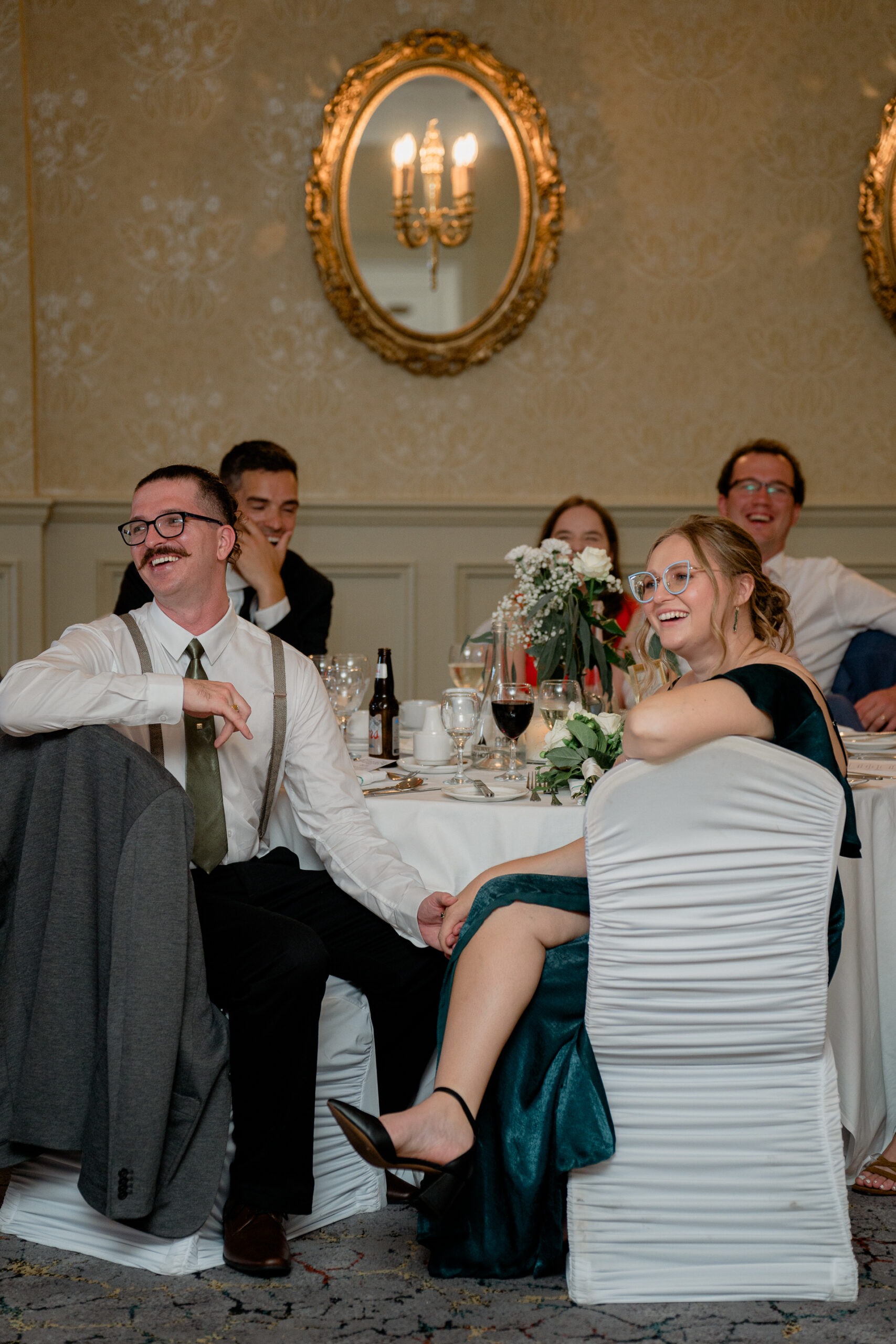 A group of people sitting at a table with wine glasses