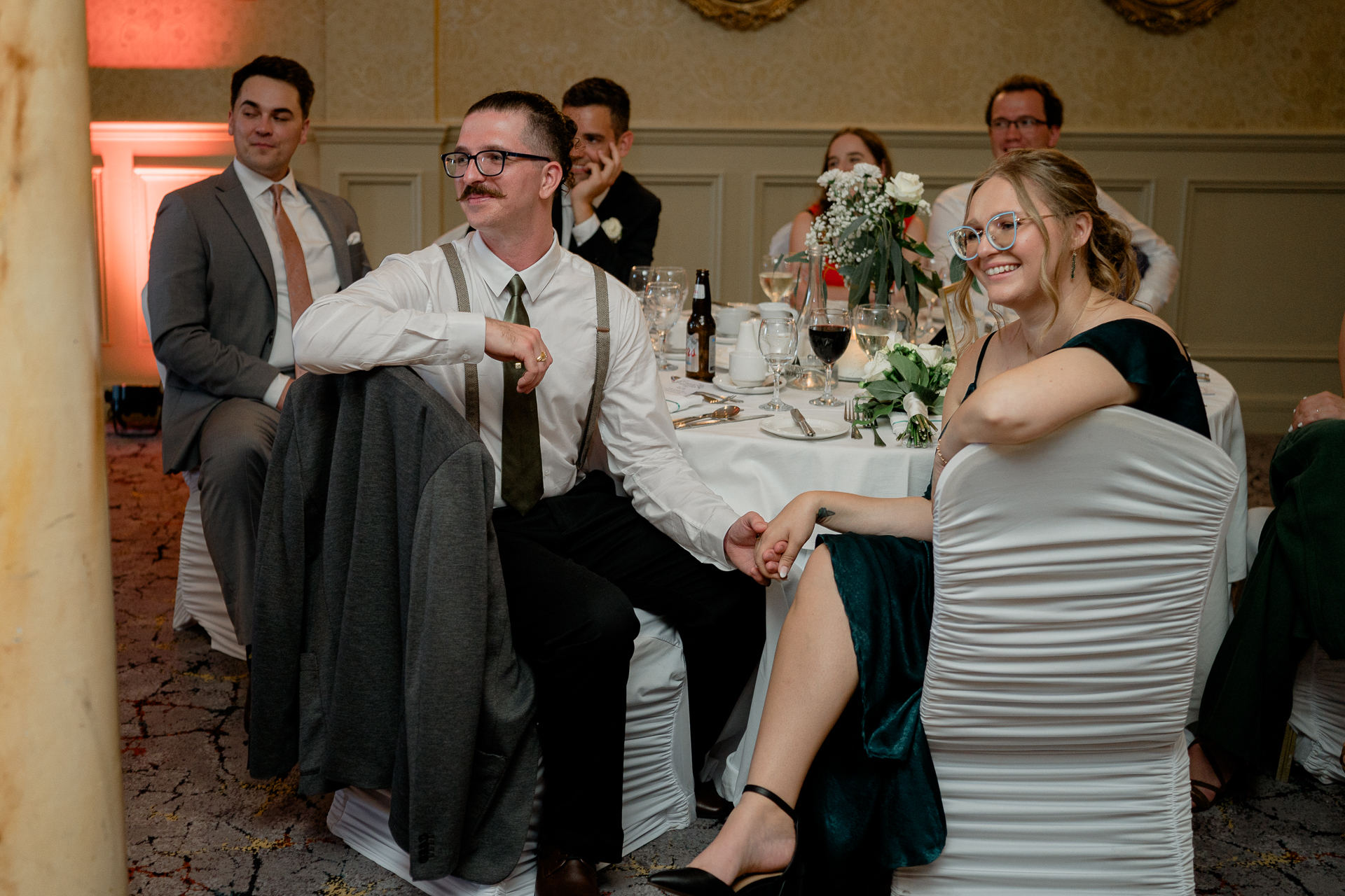 A group of people sitting around a table with wine glasses