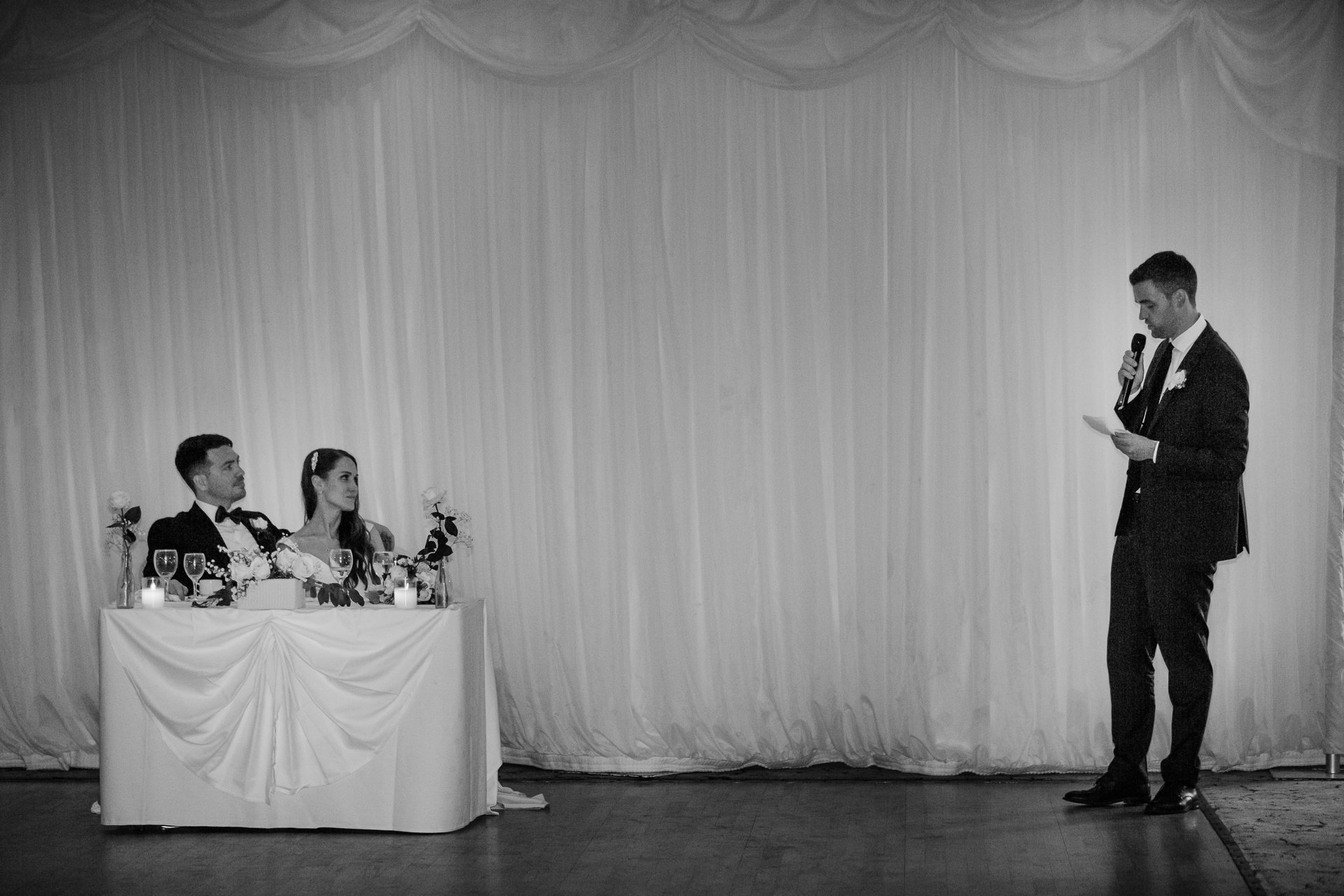 A man in a suit and tie standing next to a woman in a dress