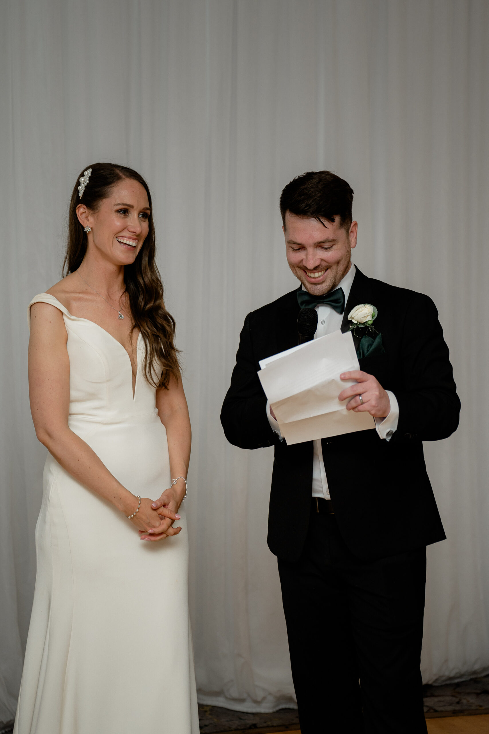 A man and woman holding a piece of paper