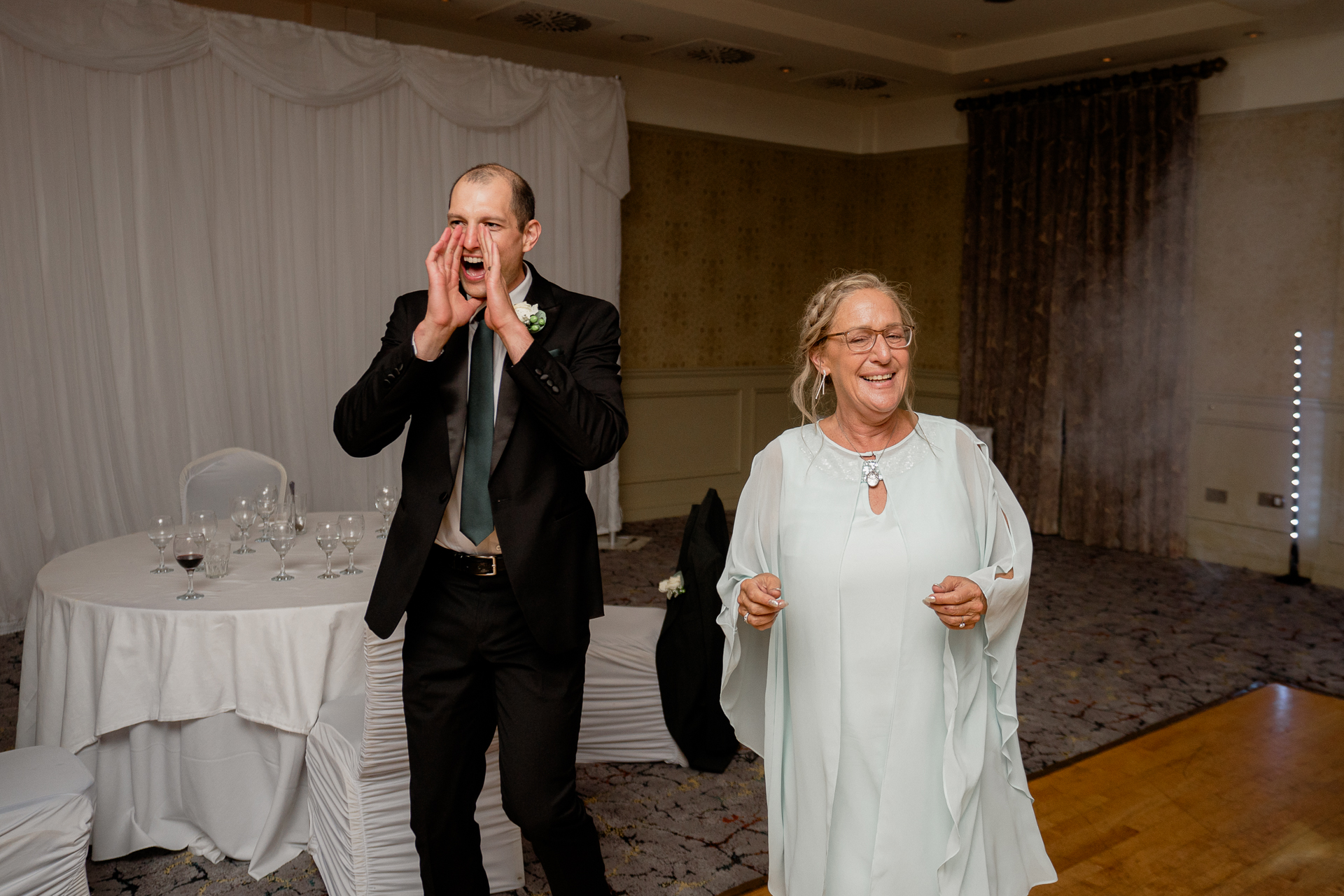 A man talking on a cell phone next to a woman in a dress