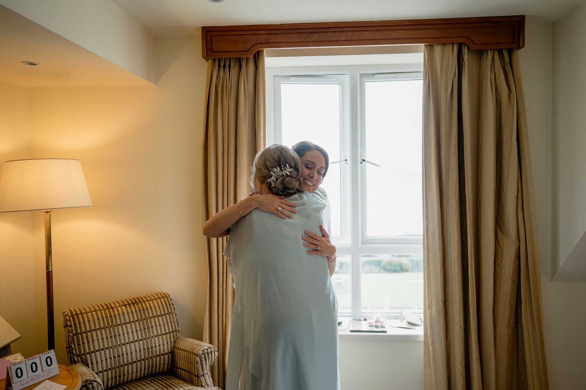 A woman in a white dress holding a man in a white robe