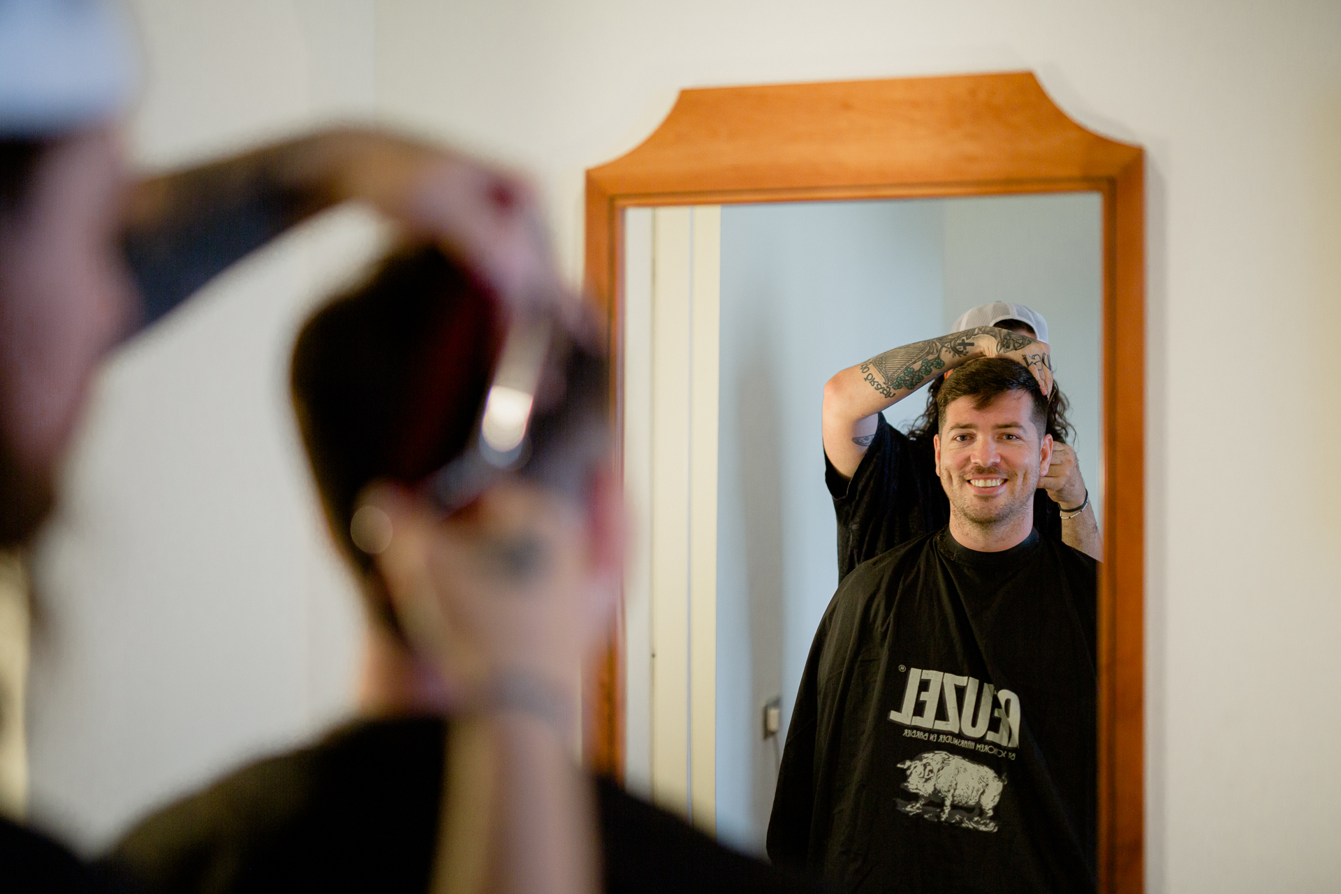 A person in a hat looking at a mirror