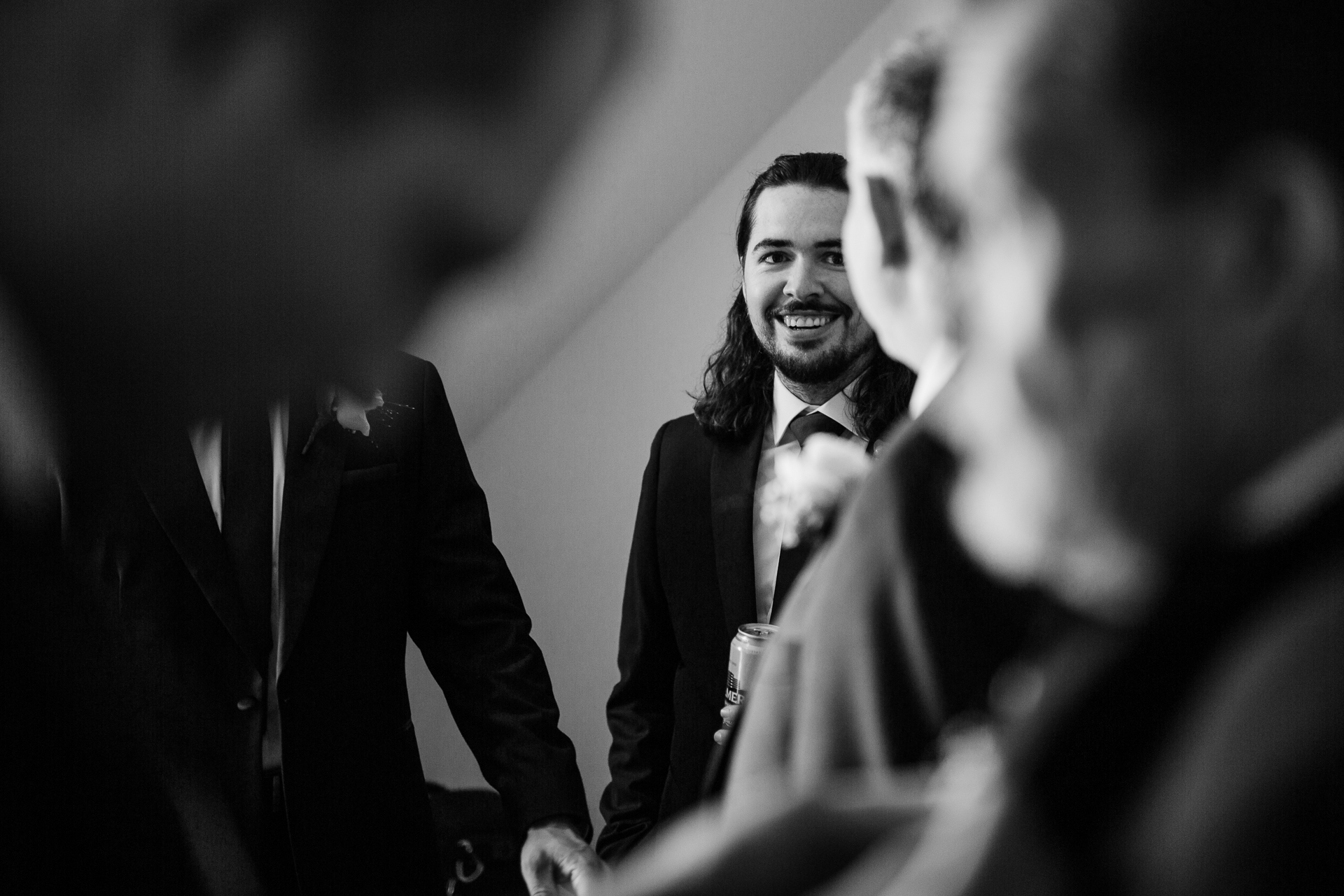 A person in a suit and tie smiling at another man in a suit