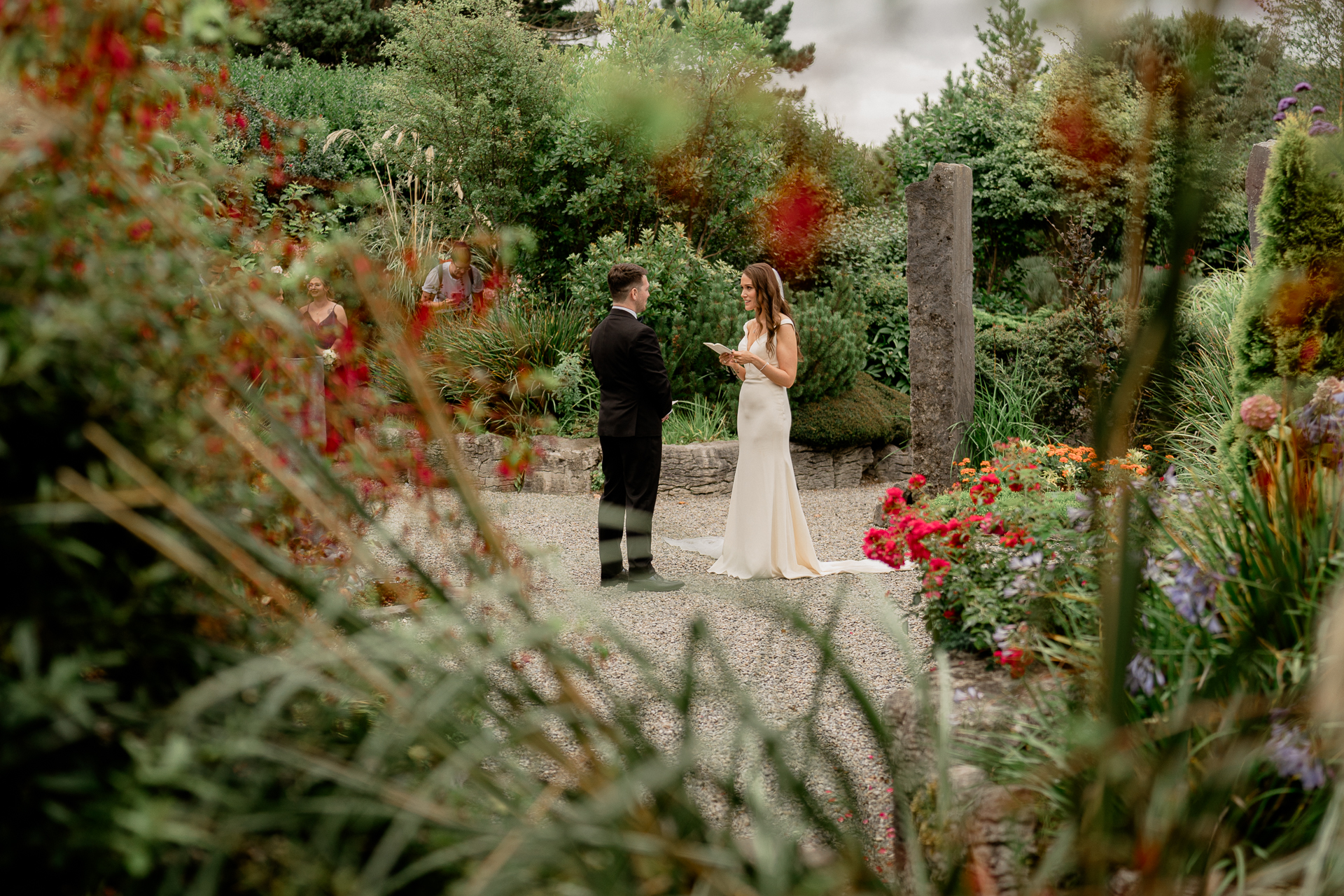 A man and woman walking in a garden